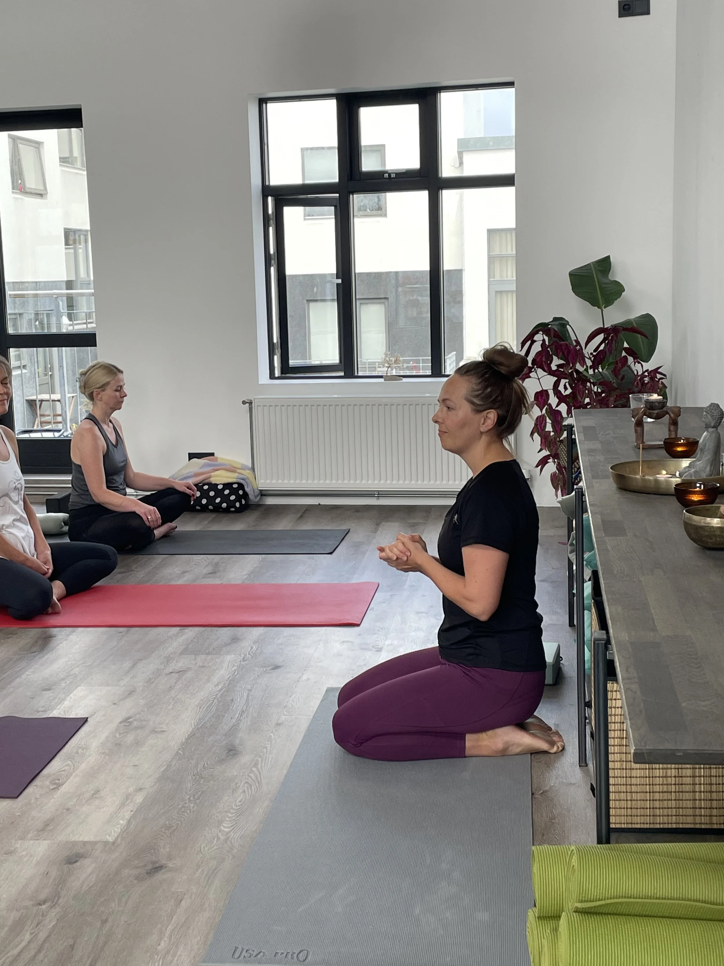 Kristin teaching yoga in a bright, modern studio.