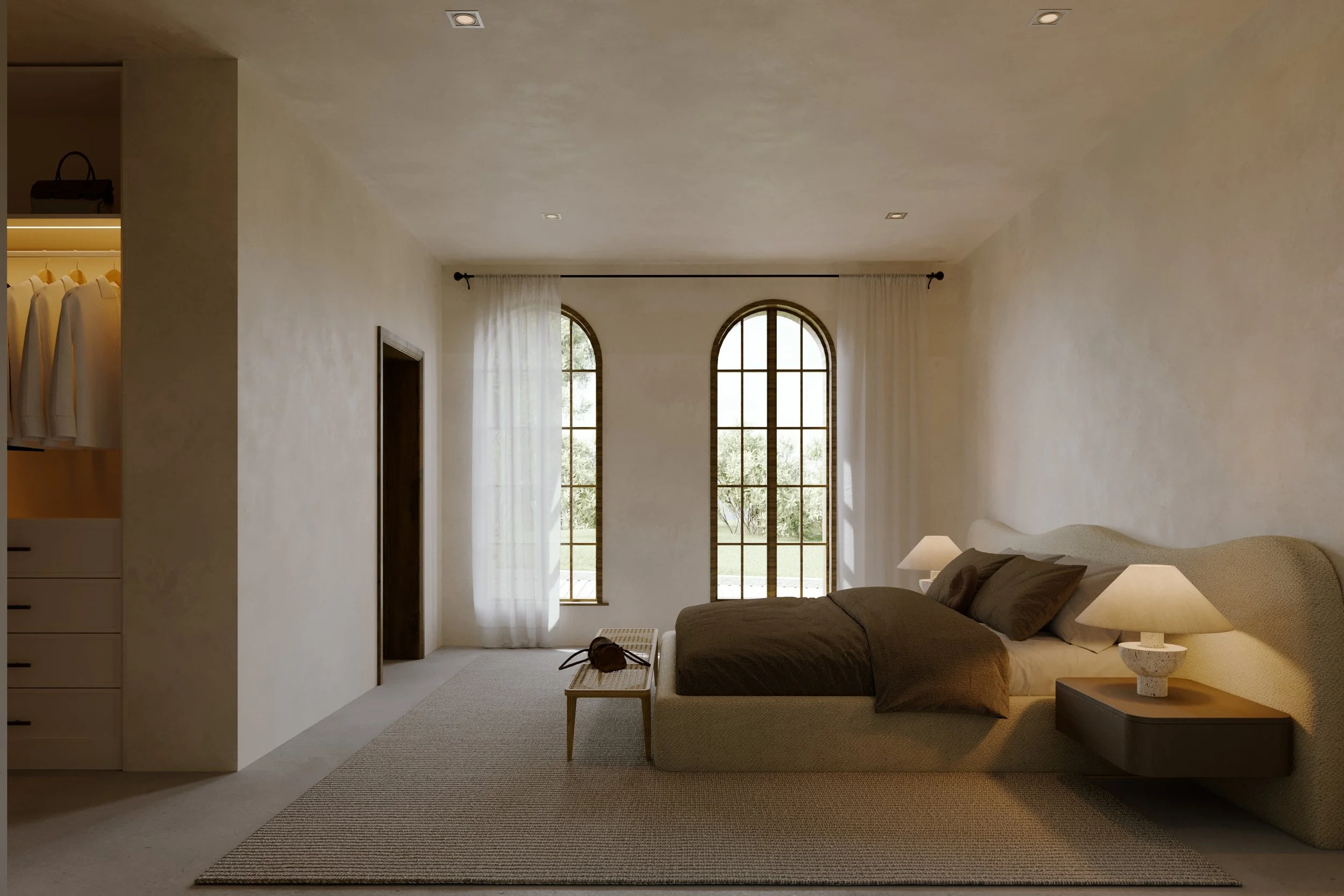 Minimalist bedroom with large arched windows, neutral-colored bed, white curtains, bedside lamps, and an open closet with hanging clothes.