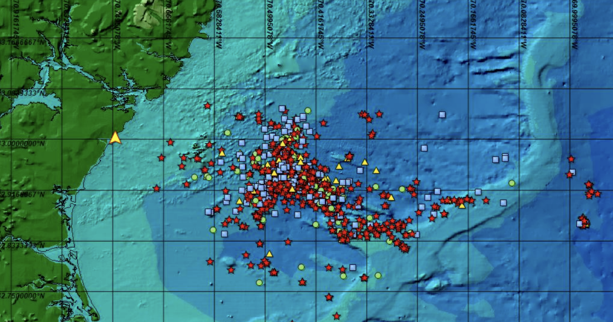 Map showing earthquake activity in the Atlantic Ocean near the southeastern coast of the United States, with various colored symbols representing different earthquake data points.