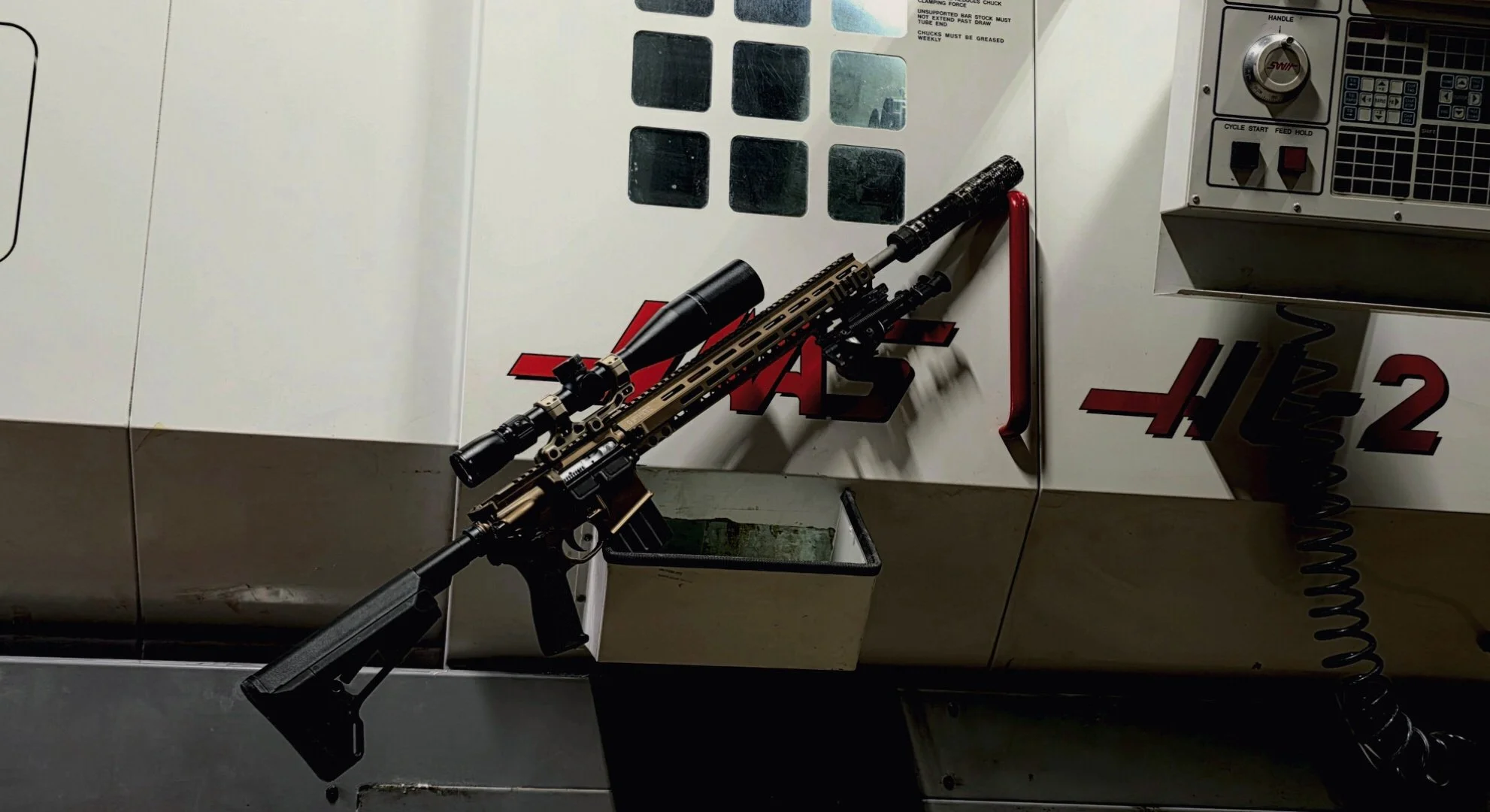 AR-15 rifle setup on workbench at Nexus Defense & Machine Co during assembly and inspection
