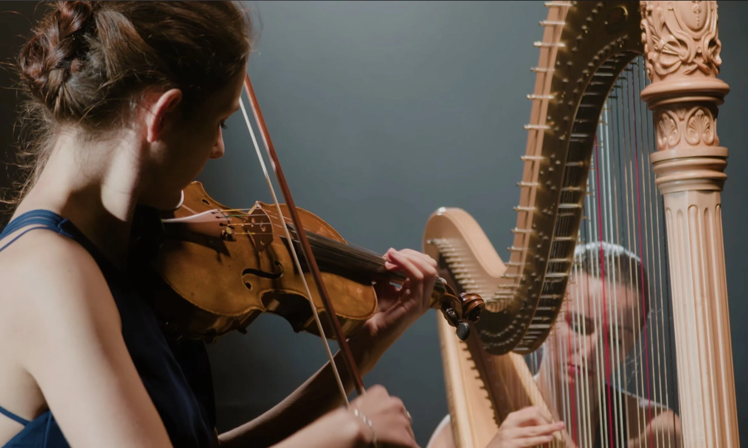 Duo Arsis Thesis avec harpe et violon dans un espace contemporain et lumineux.