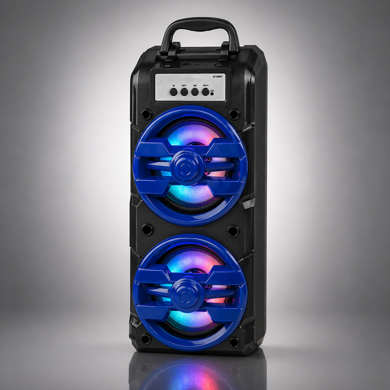 Black portable speaker with two large blue speaker grilles and multicolored LED lights inside, on a gray background.
