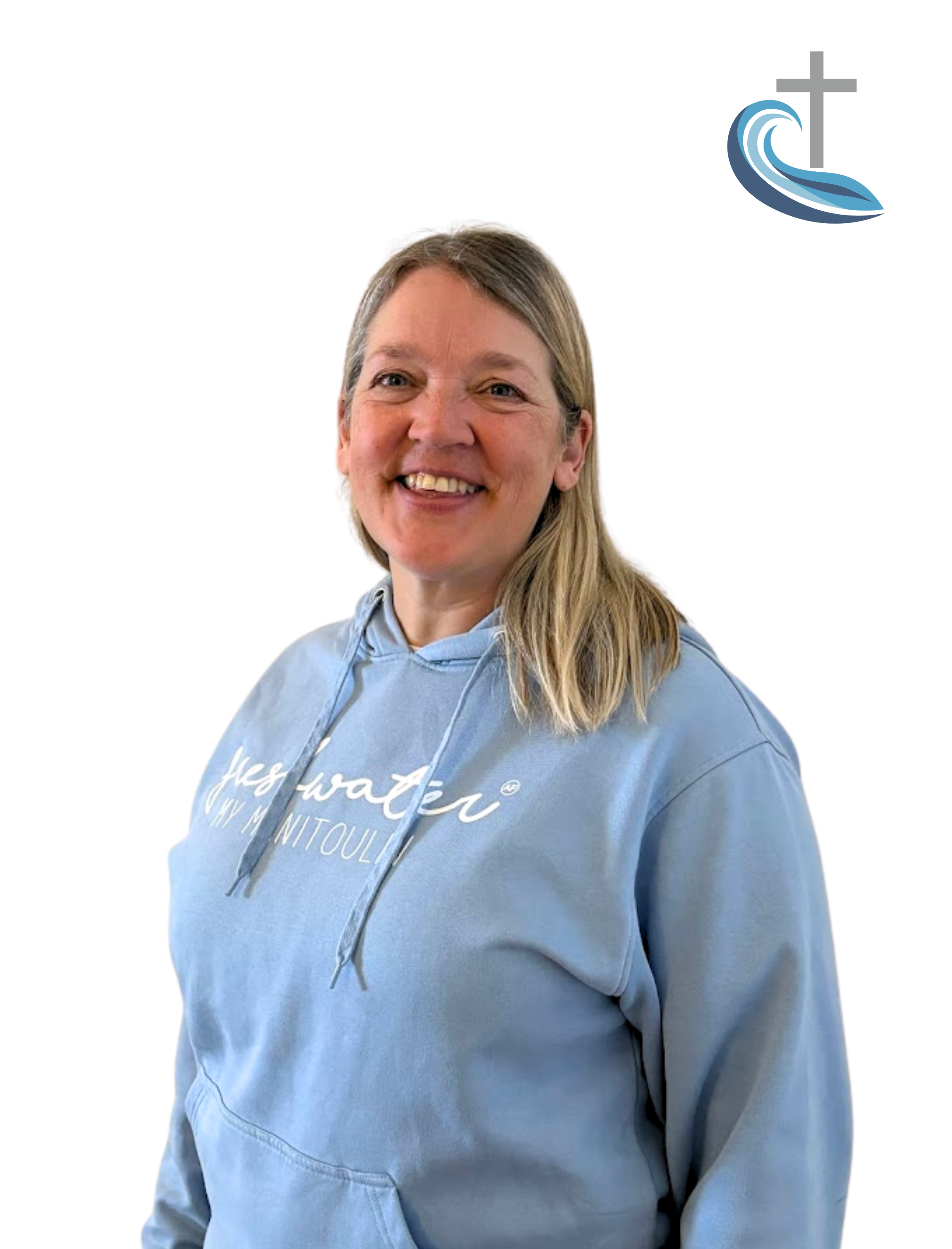 A woman smiling, wearing a light blue hoodie with white text, standing against a white background with a church logo in the top right corner.