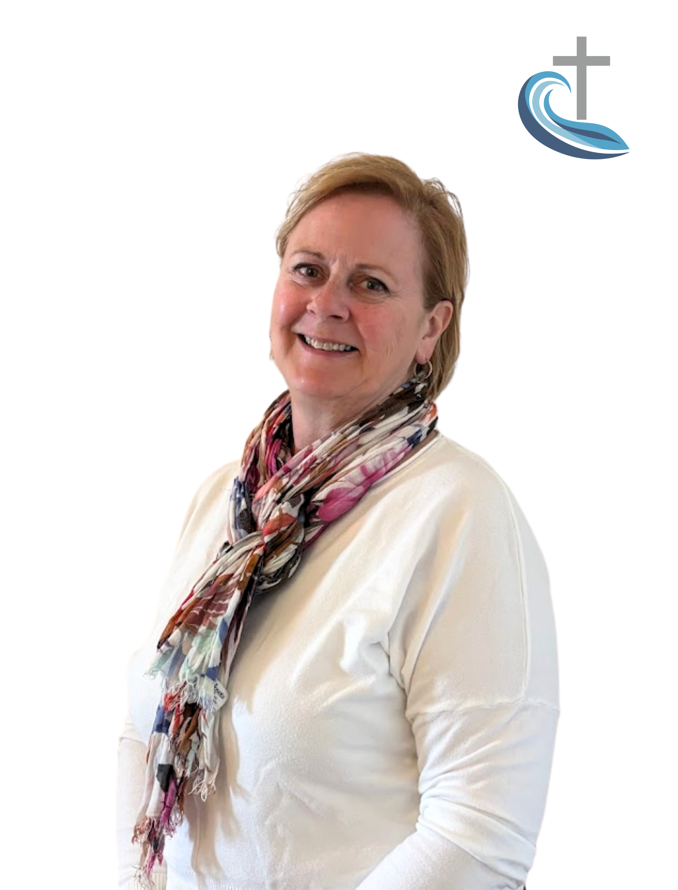 Smiling woman with short_yellow hair, wearing a white top and a colorful floral scarf, standing against a plain white background with a graphic of a cross and water in the top right corner.