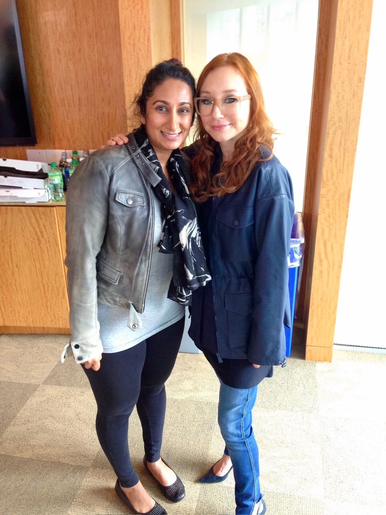 The Pearl Edge founder Parul "Pearl" Chokshi with Tori Amos; pictured is one woman having dark hair and the other red hair, wearing casual jackets, jeans, and high heels.