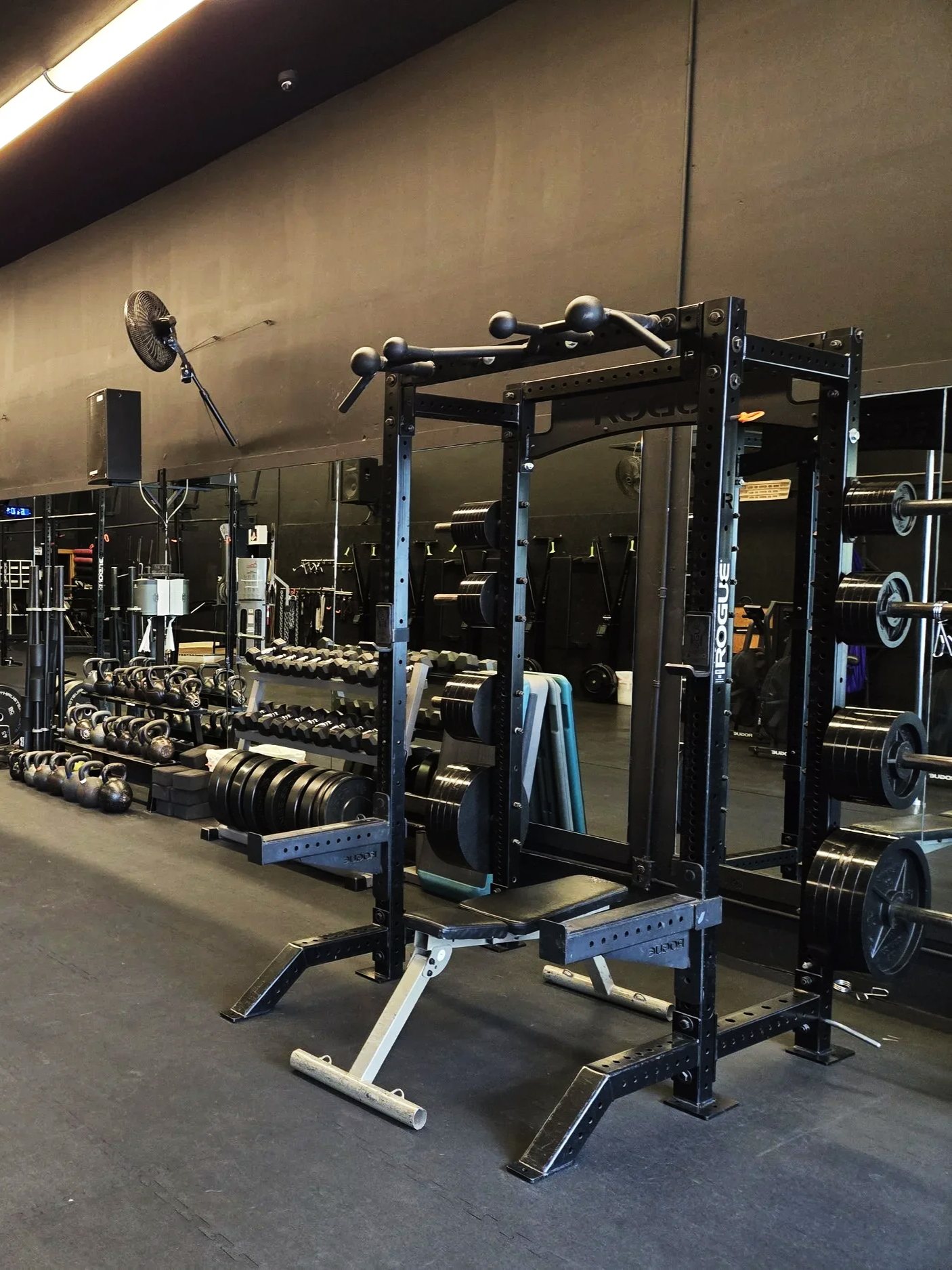 Image of kettlebell, plate racks, and other gym equipment