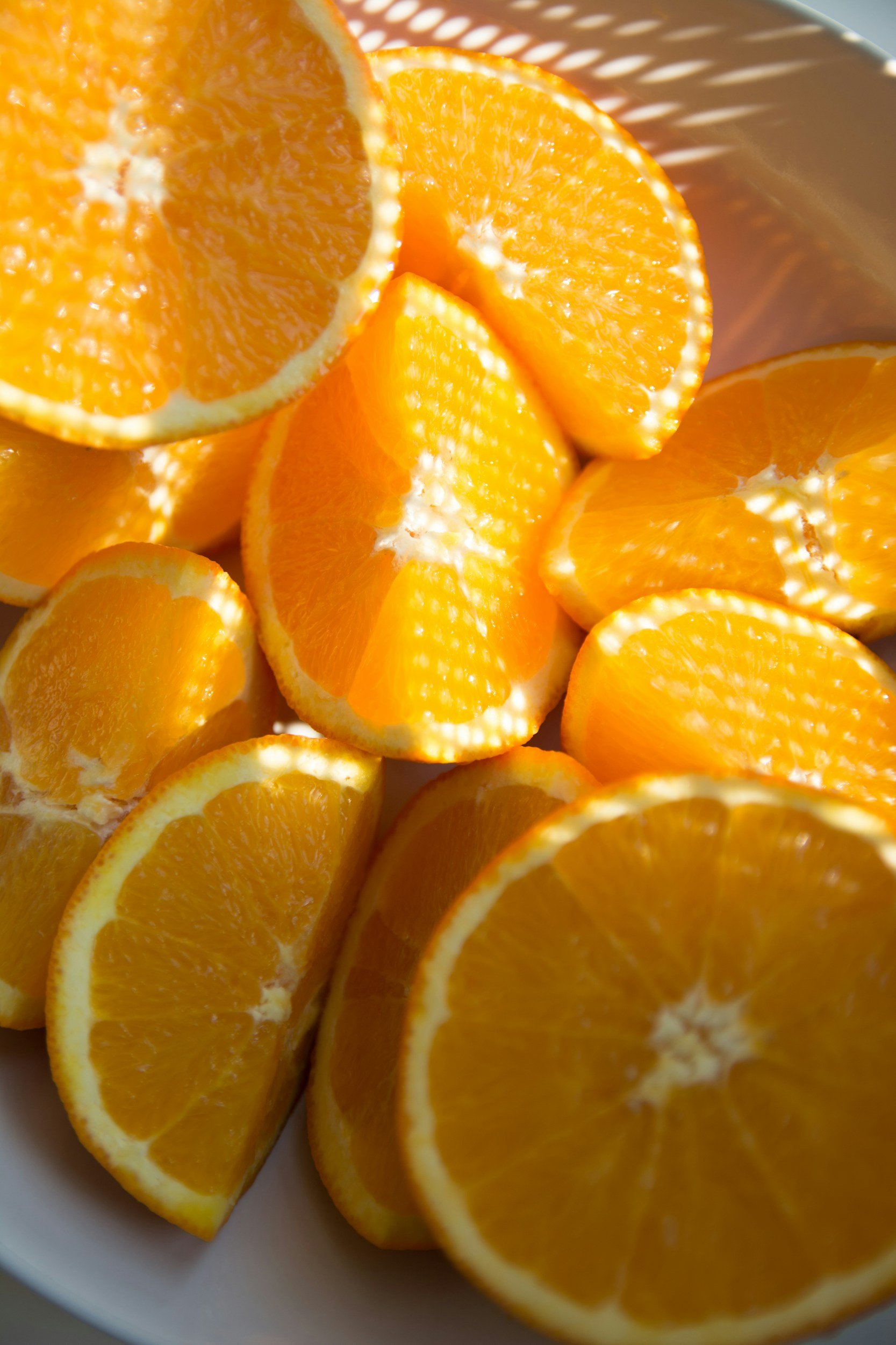 Sliced oranges arranged in a bowl.