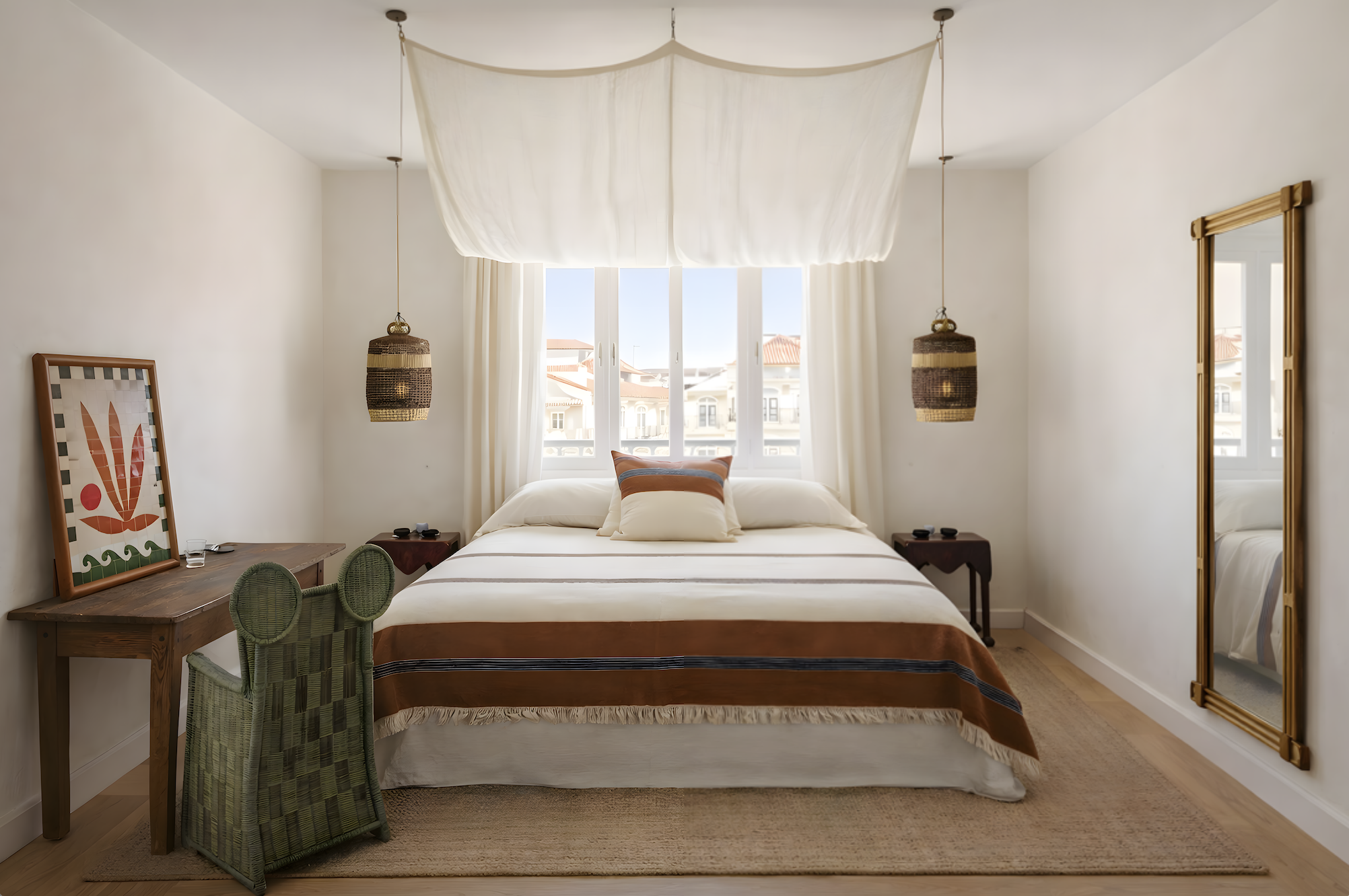 Soft neutral bedroom with suspended linen canopy, woven lighting and Mediterranean-inspired styling in Casa Atlas, Lisbon.