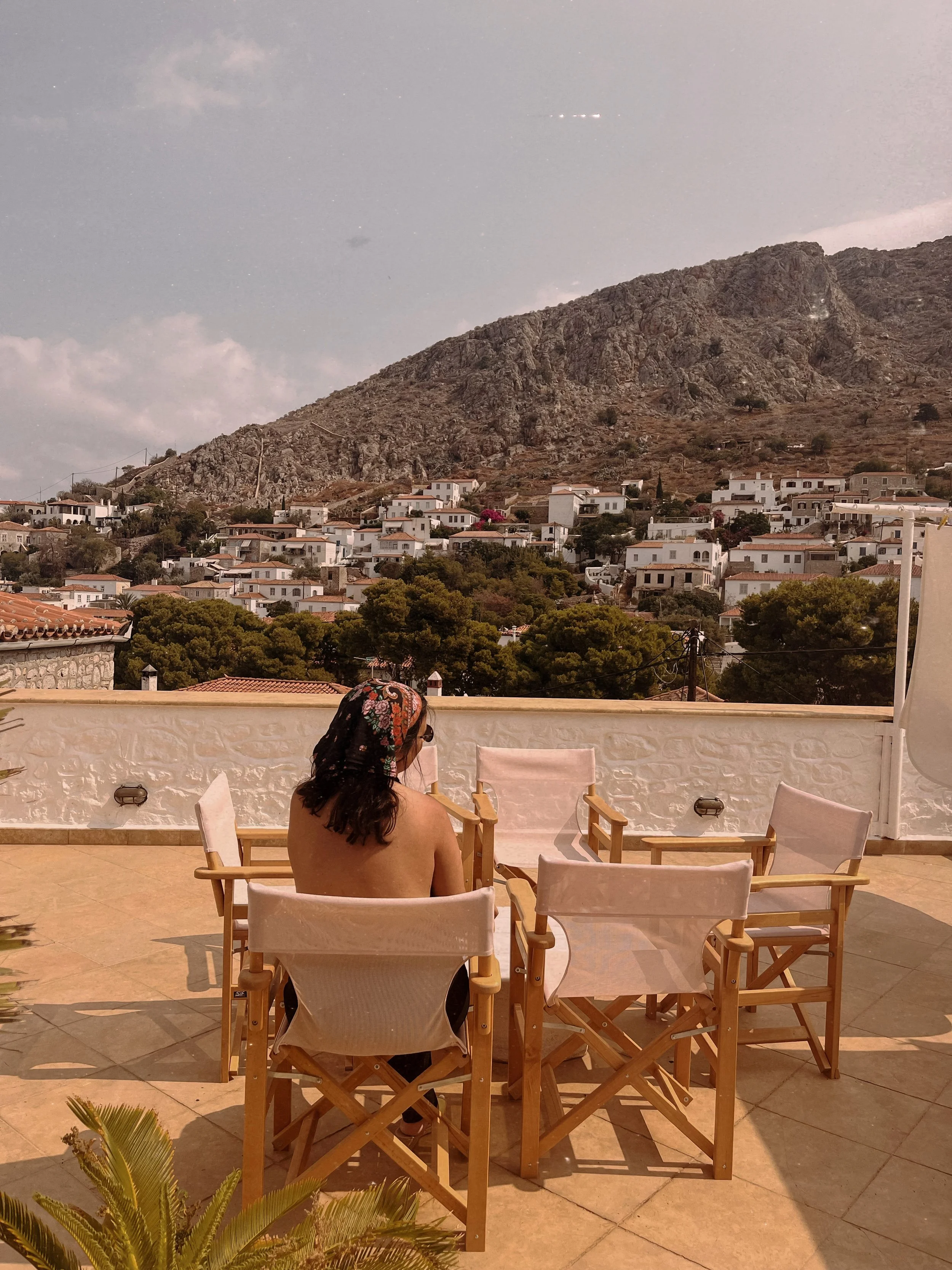 Catia Vieira on a terrace overlooking Hydra, Greece, reflecting the slow Mediterranean lifestyle and visual inspiration behind Zajal.