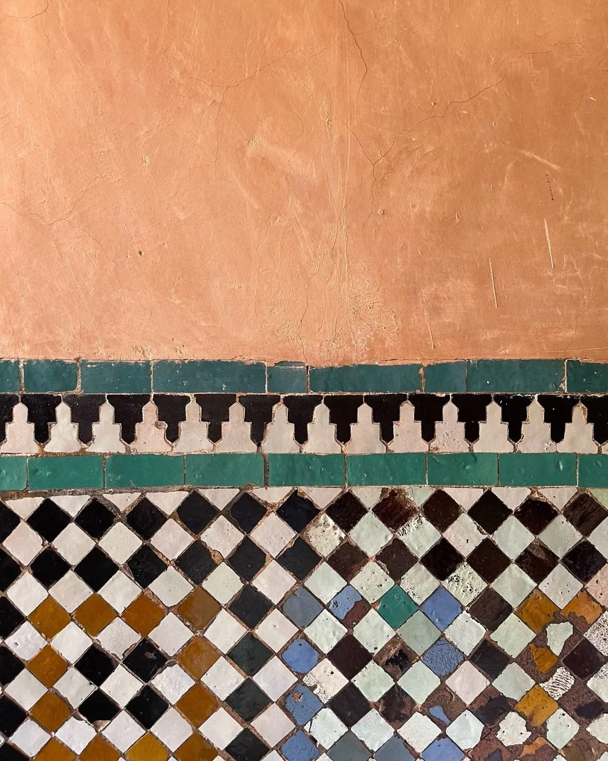 Traditional Moroccan zellige tile patterns and textured terracotta walls photographed in Tangier, Morocco.