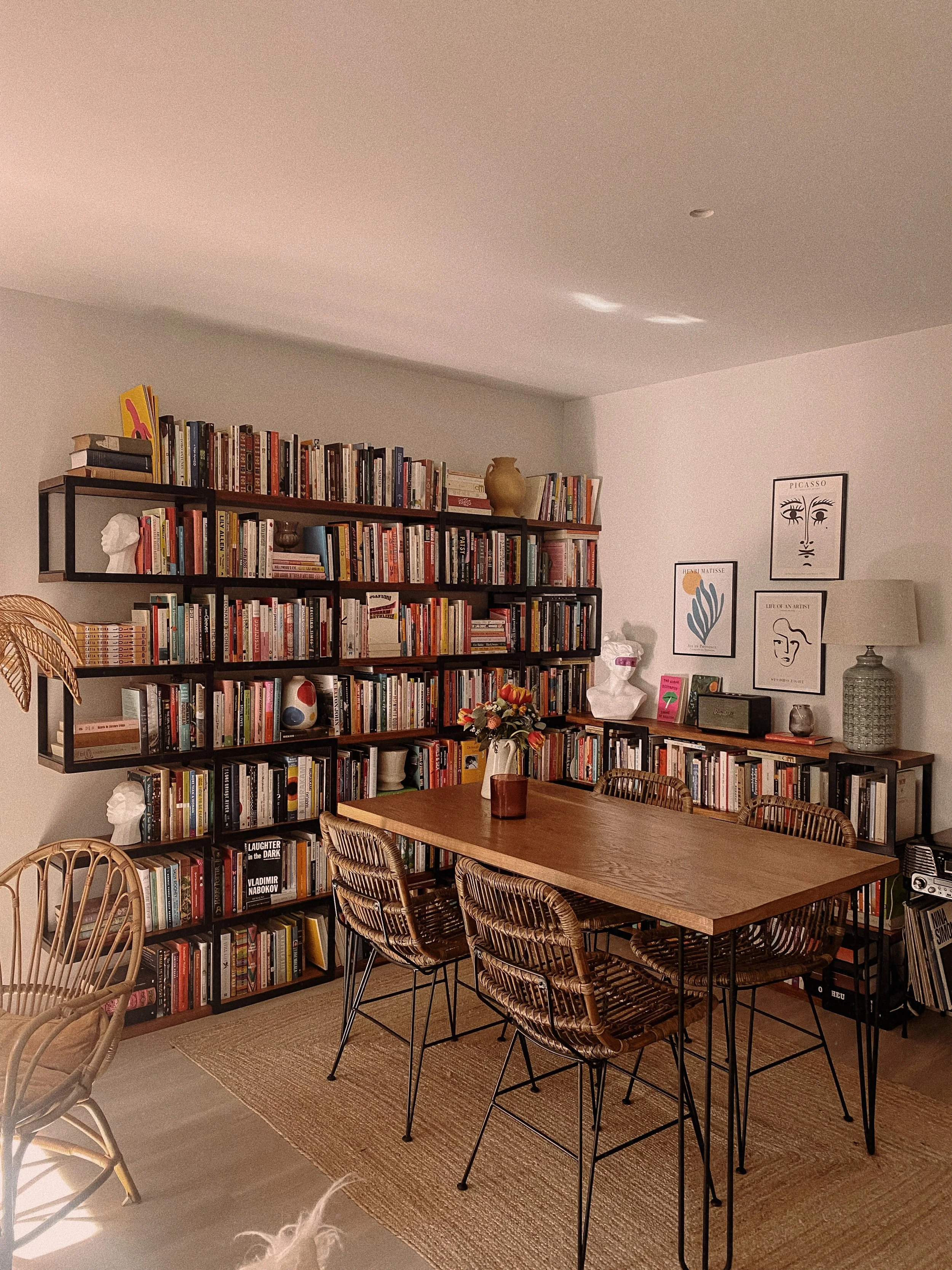 Custom-designed Paloma shelves by Cátia Vieira featuring sculptural dark wood shelving for a warm Mediterranean-inspired interior.