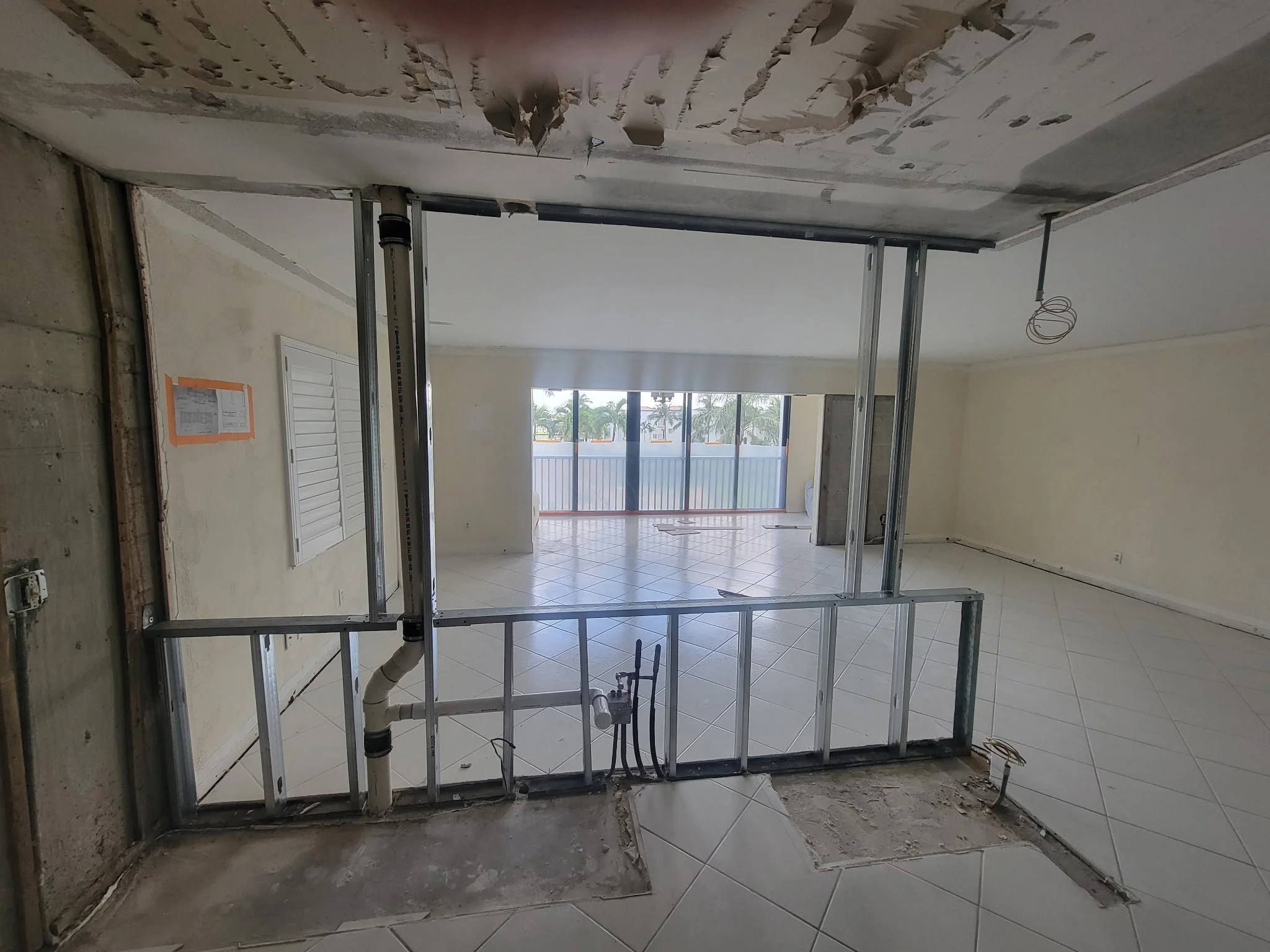 Post demo of kitchen wall in a condo.