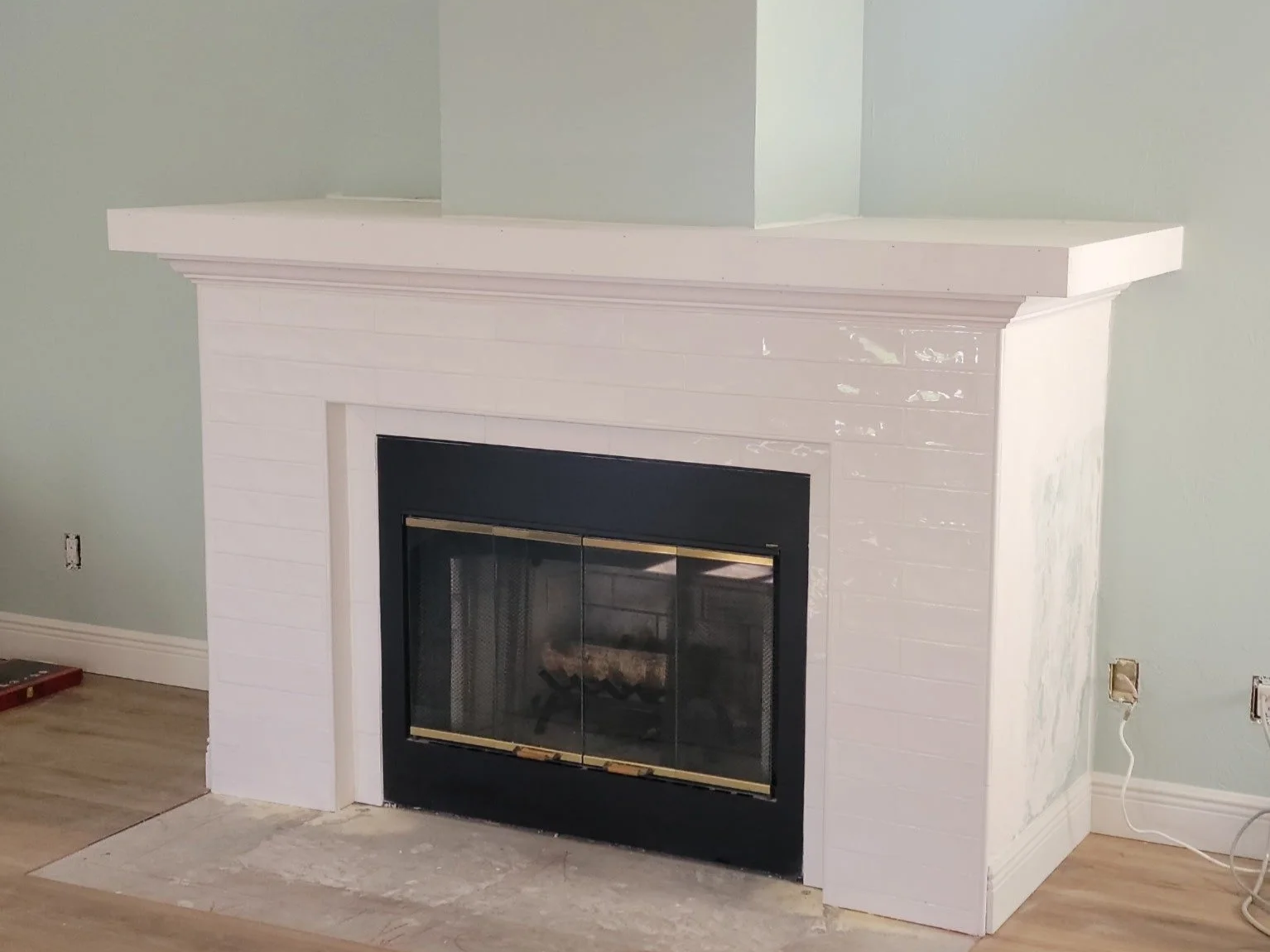 Faceplate and mantle around a fireplace built and tiled after hurricane damage.