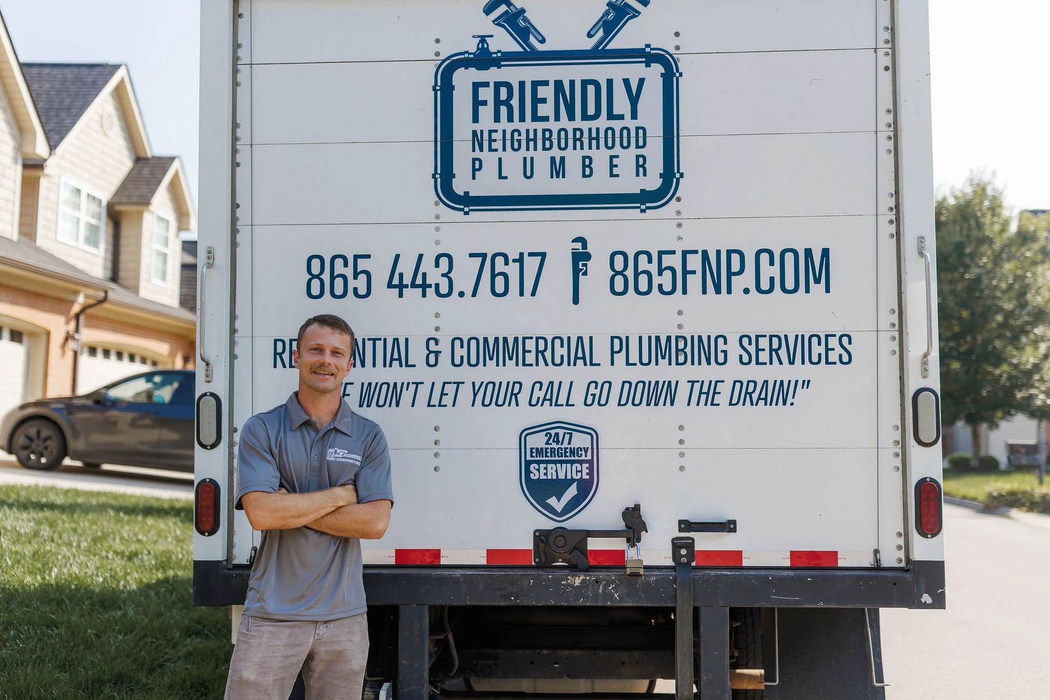 Local Knoxville plumbers standing by work truck