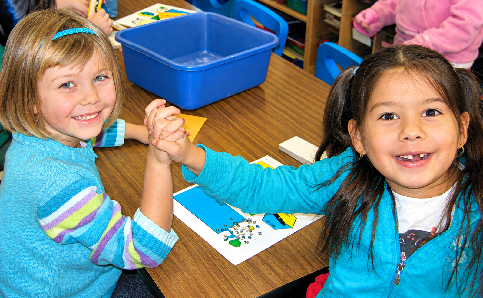 Children learn to smile, high-five and say "good job!"