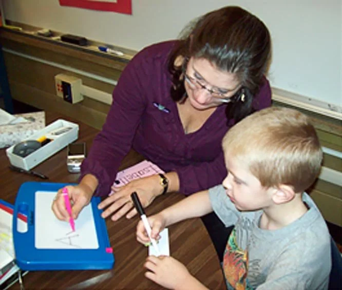 early learners get handwriting coaching from teachers