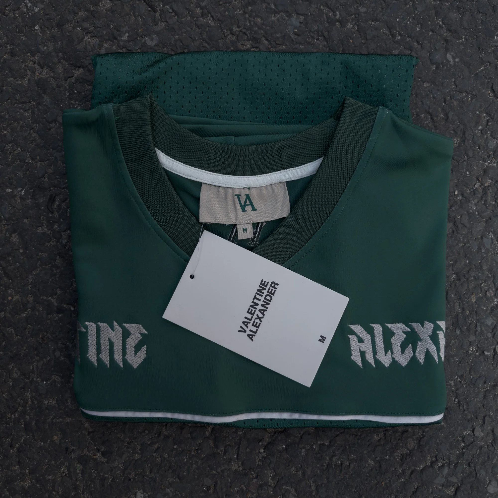Valentine Alexander 77 Jersey in Forest Green, folded on concrete
