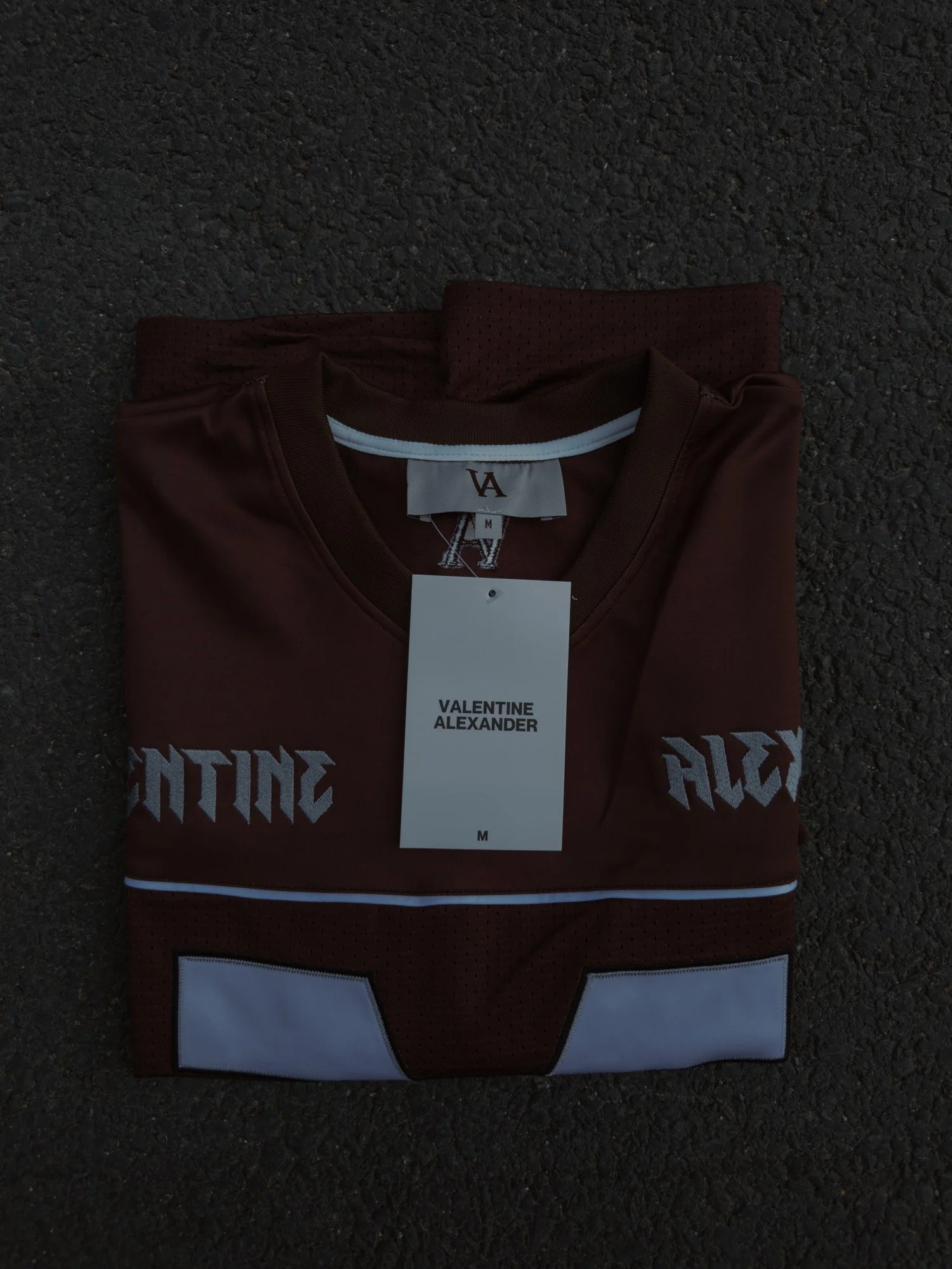 Valentine Alexander 77 Jersey in Vintage Brown, folded on concrete