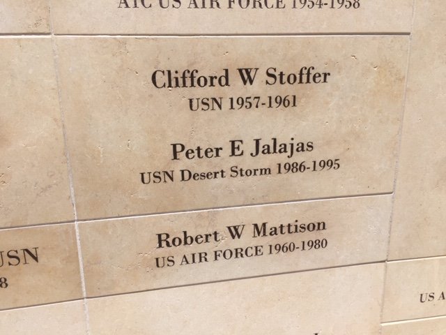 Names of military personnel and their service details engraved on a commemorative plaque, including Clifford W Stoffer, Peter E Jalajas, and Robert W Mattison.