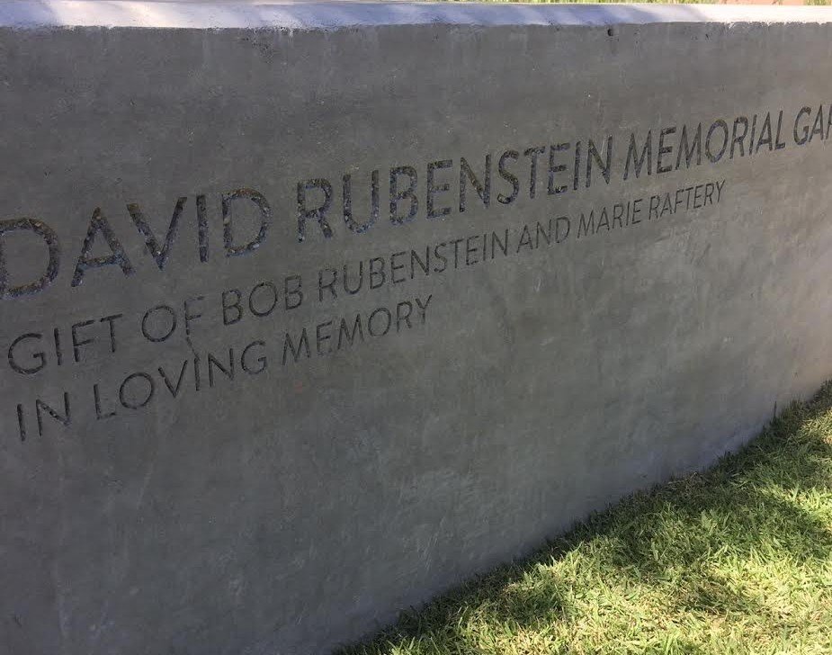 Close-up of a memorial plaque with engraved text honoring David Rubenstein, donated by Bob Rubenstein and Marie Raftery.