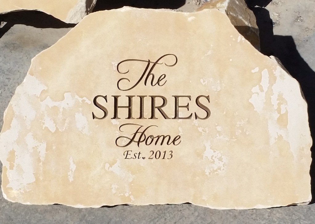 A beige stone with engraved text that reads 'The SHIRES Home Est. 2013'.