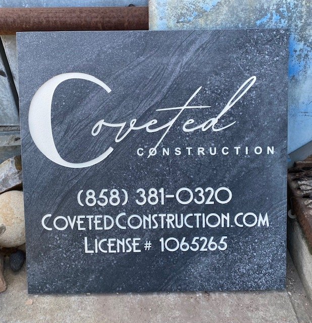 Sign for Coveted Construction with a phone number, website, and license number.