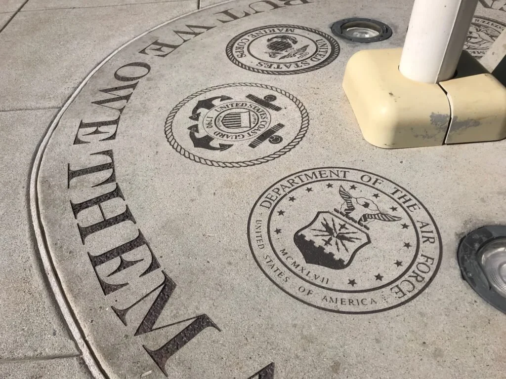 Seal of the Department of the Air Force on the ground at an outdoor location.