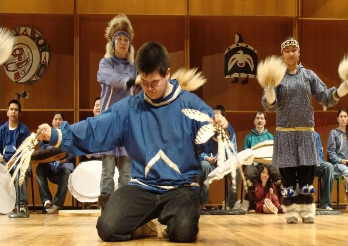 alaska native dancer using dance fans with bird feather materials