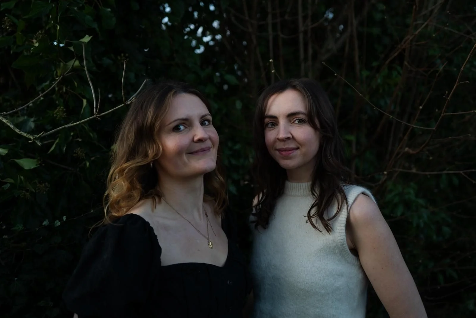 Elin and Carys, Welsh folk sister duo, outdoor portrait surrounded by greenery