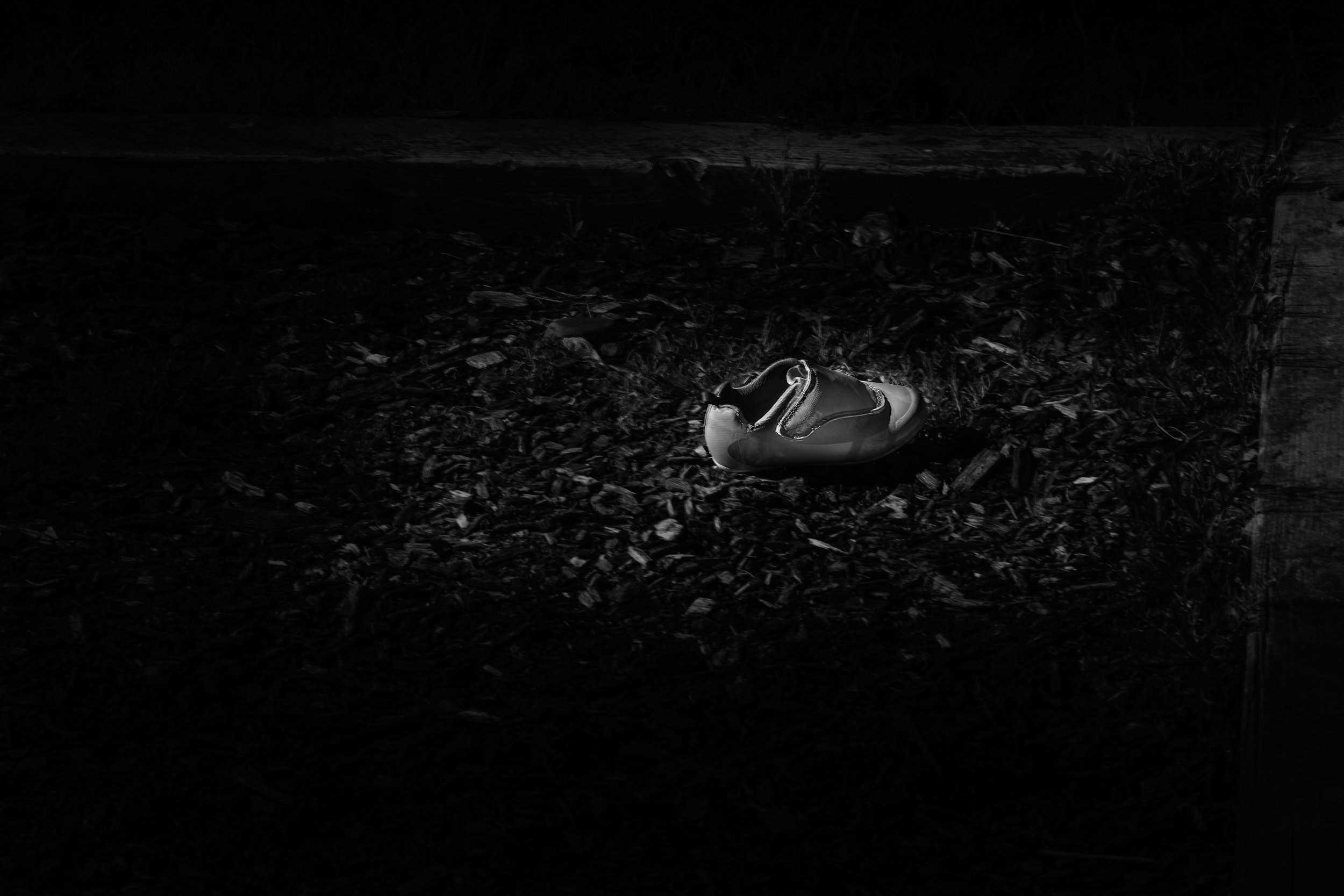 Why
A child's shoe, left behind on a playground in absolute darkness. No answer remains