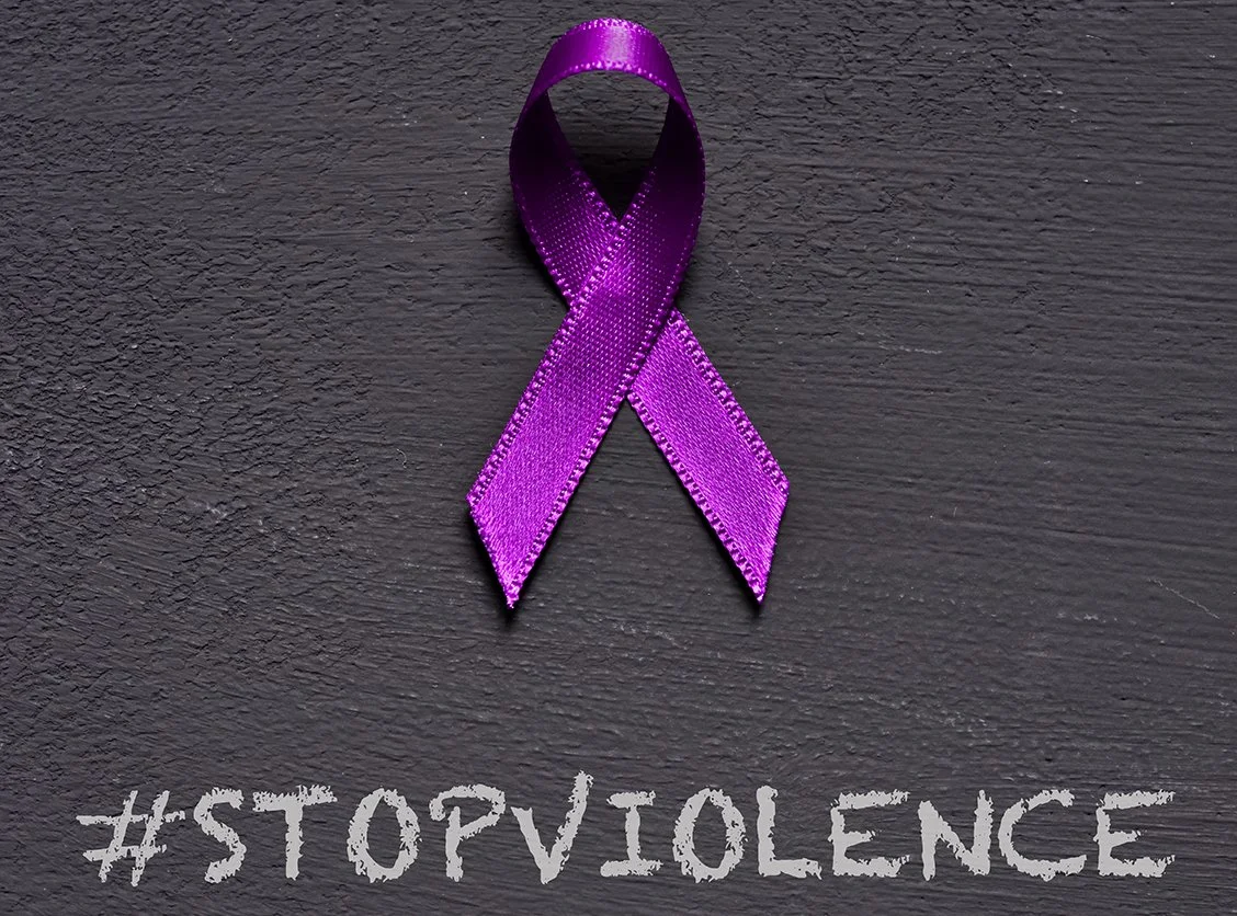 Purple awareness ribbon on a dark gray background with the hashtag #STOPVIOLENCE written below.