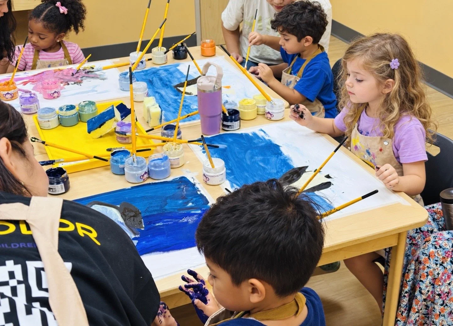 Children creating art together in a Little Explorers class
