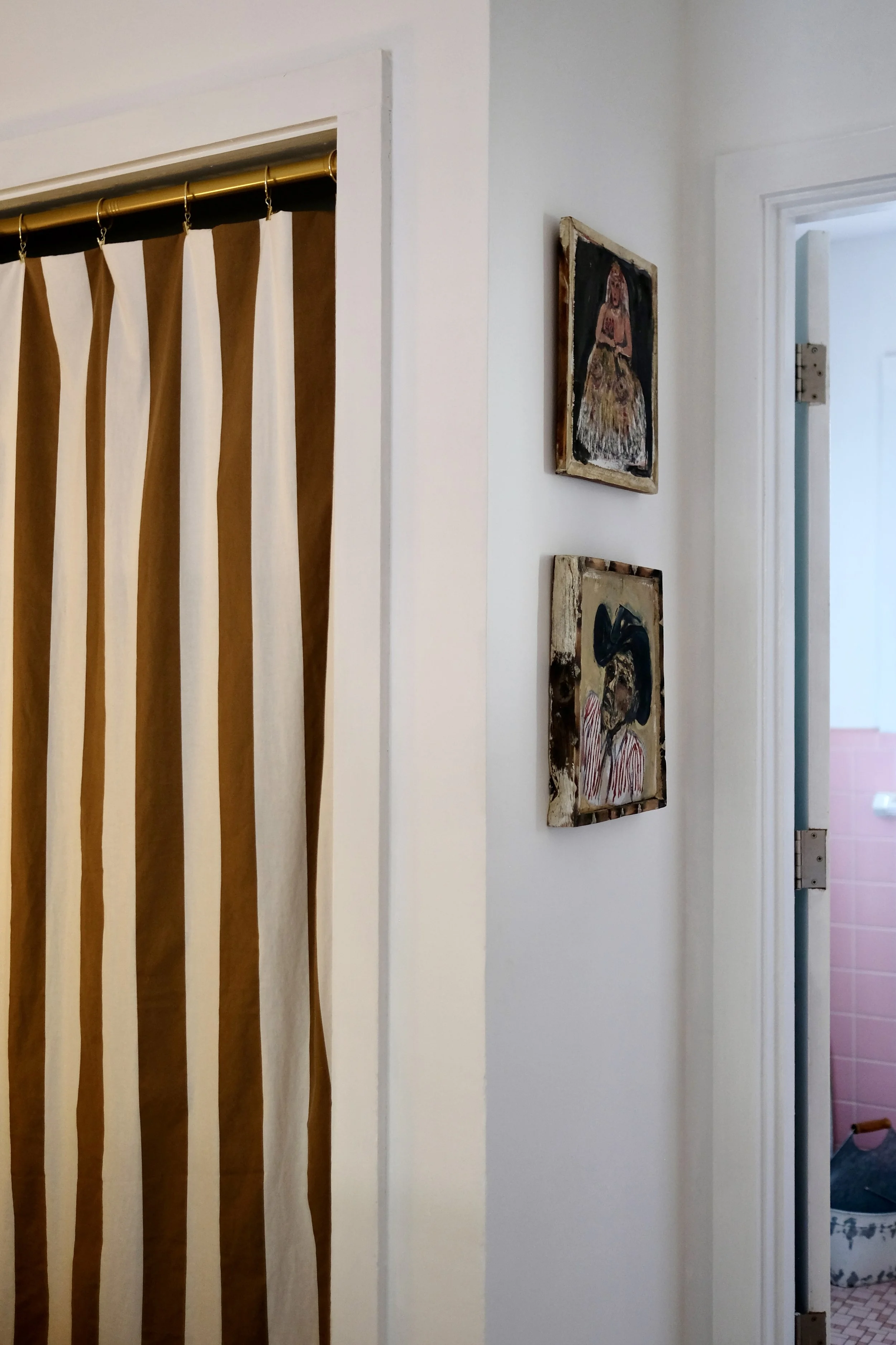 George Zupp paintings installed beside the striped curtain in Room 11 at Dame Fortune’s Cottage Court.