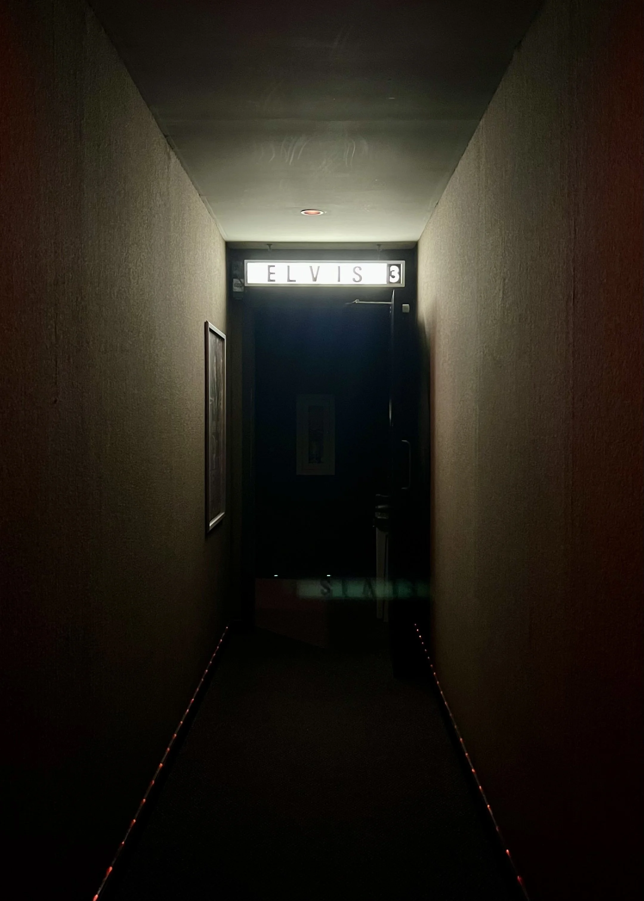 Dimly lit hallway and Elvis 3 room entrance, photographed by Tinderbox Studio.