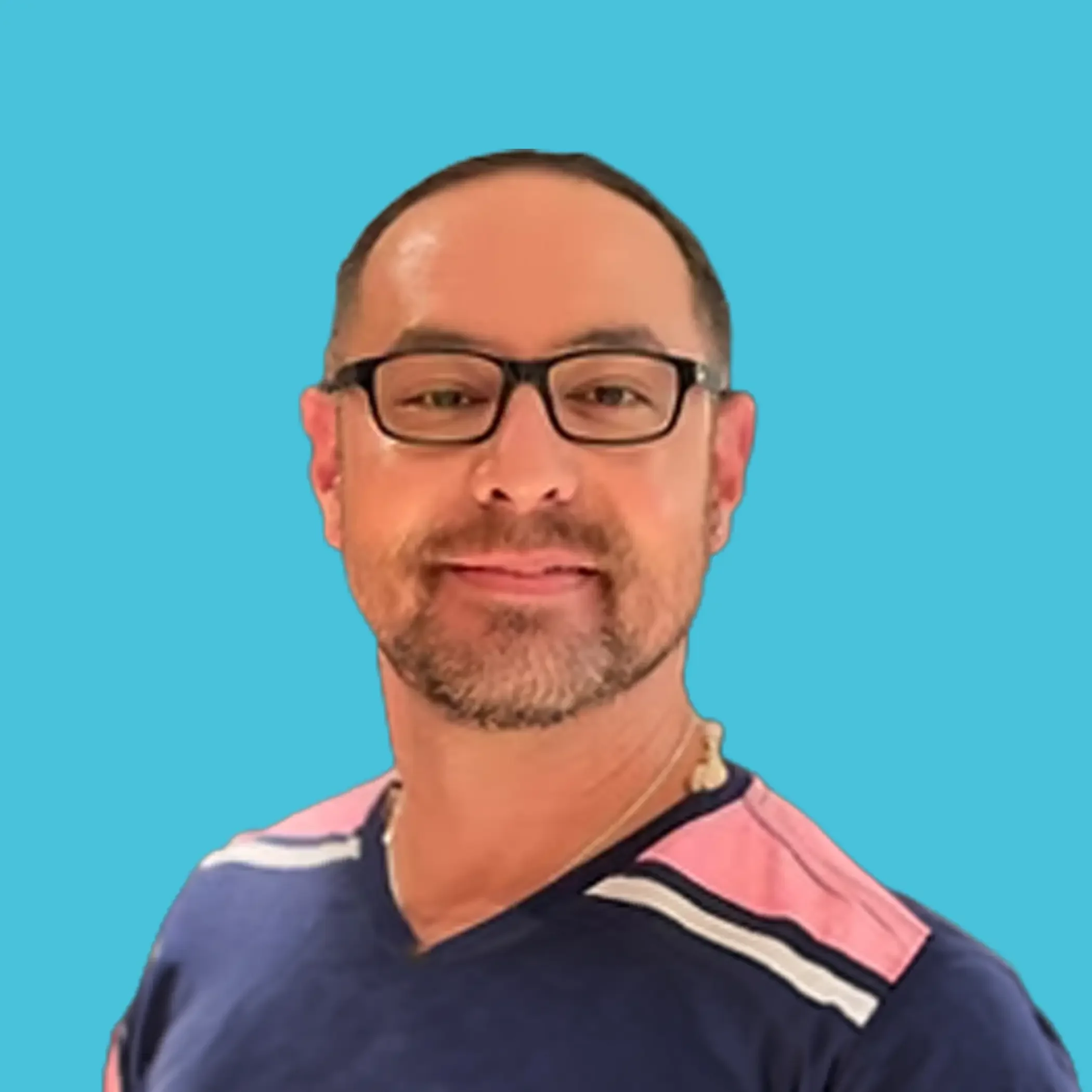 Close-up of a man with glasses, short hair, and a beard, wearing a striped shirt, smiling.