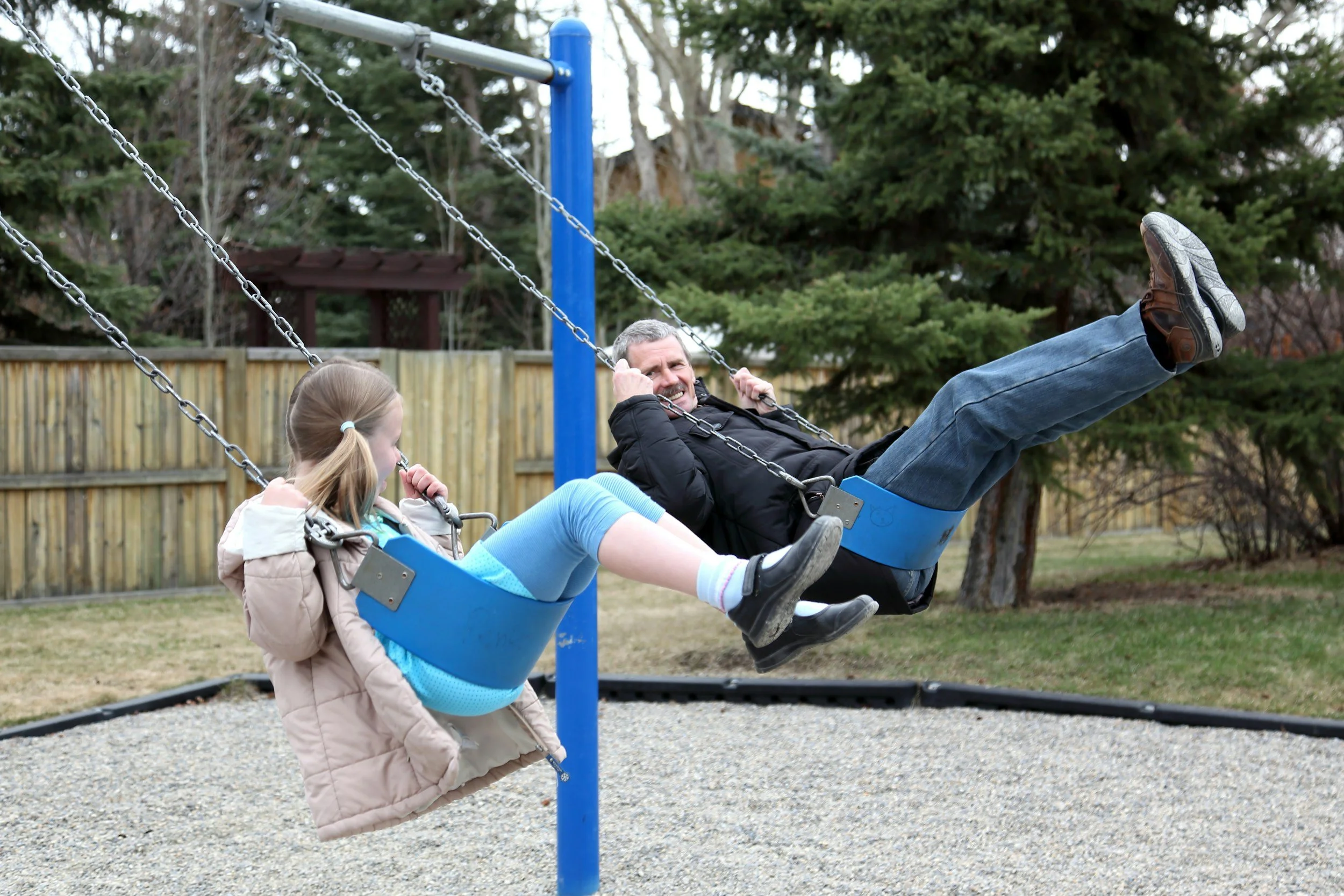 father and daughter on a swing