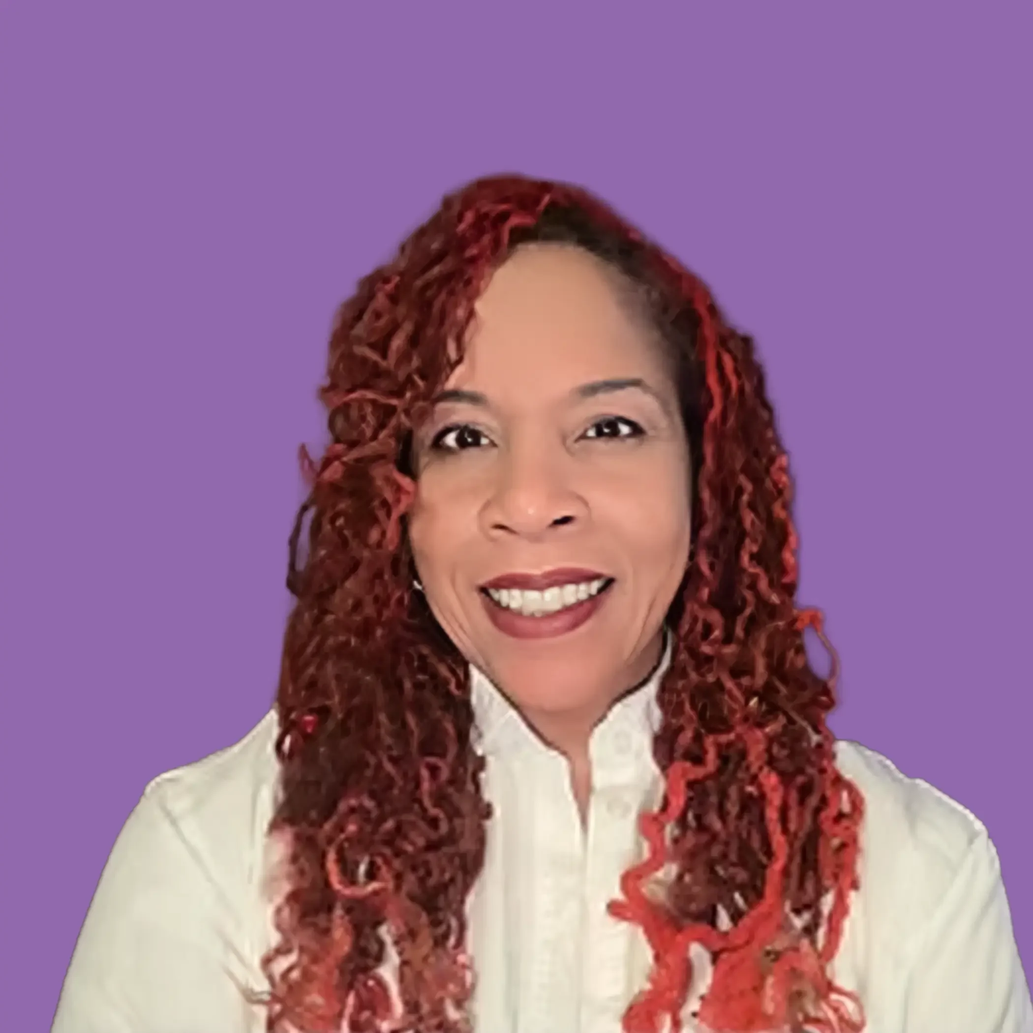 A woman with curly red hair smiling, wearing a white shirt, against a purple background.
