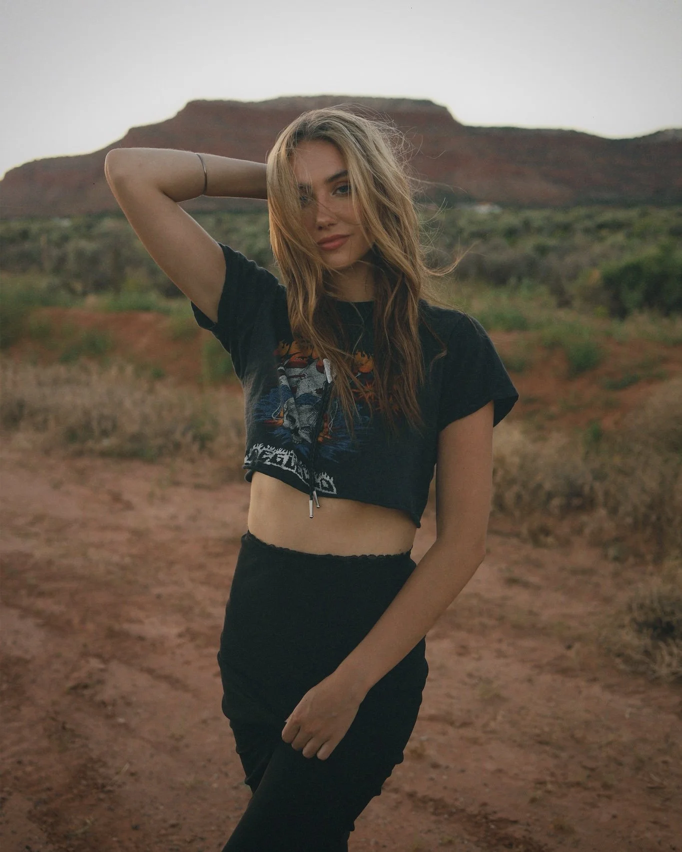 A woman posing in front of red rocks in Southern Utah.