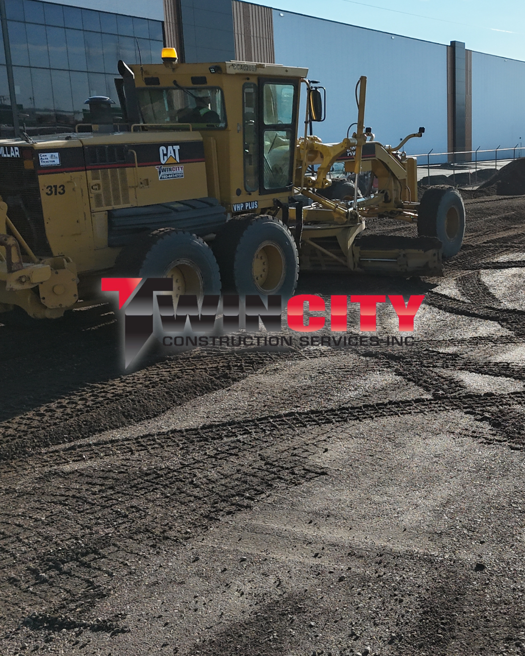 A construction site with a yellow CAT VHP Plus road grader on dirt ground, with the Twin City Construction Services Inc. logo overlayed.