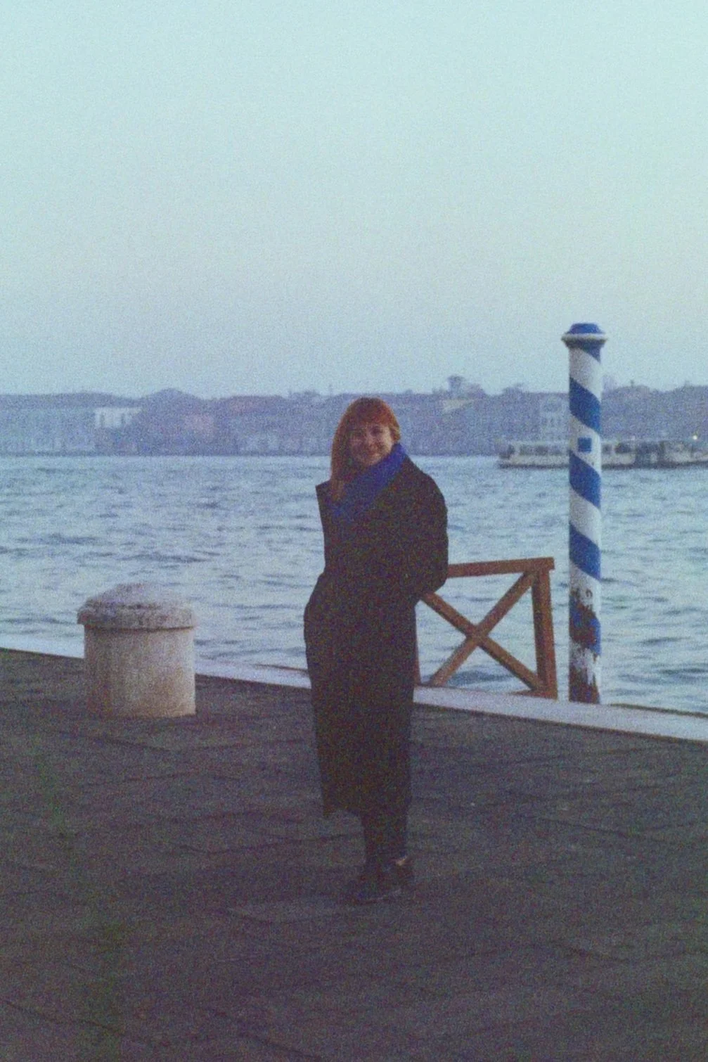 Writer and Writing Venice facilitator standing near the lagoon in Venice.