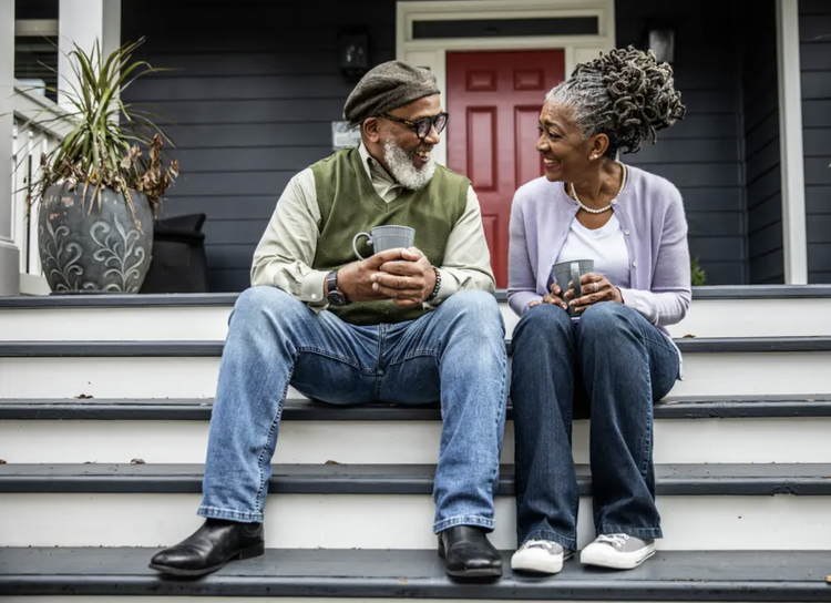 Older adults sitting outside at home
