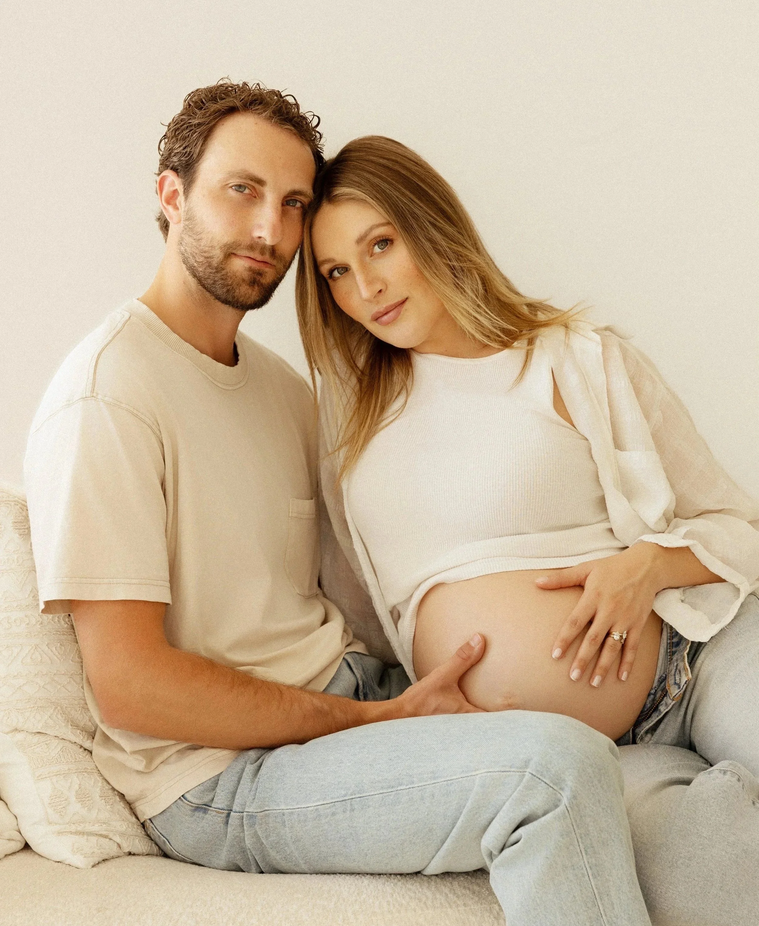 Pregnant couple holding baby bump during a Southern California maternity photography session serving the Inland Empire, Orange County, and Los Angeles County.