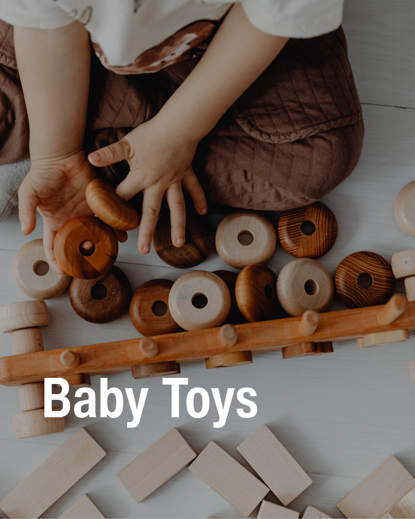 A baby's hands playing with the resale baby toys that Chic Kids sells.