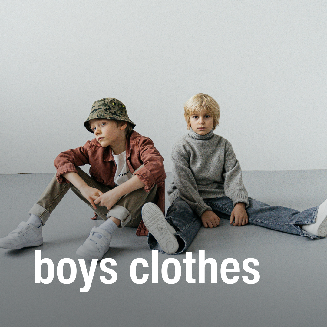 Two young boys sit on the floor in casual clothes from a children’s resale store with the text “boys clothes” in large white letters at the bottom.