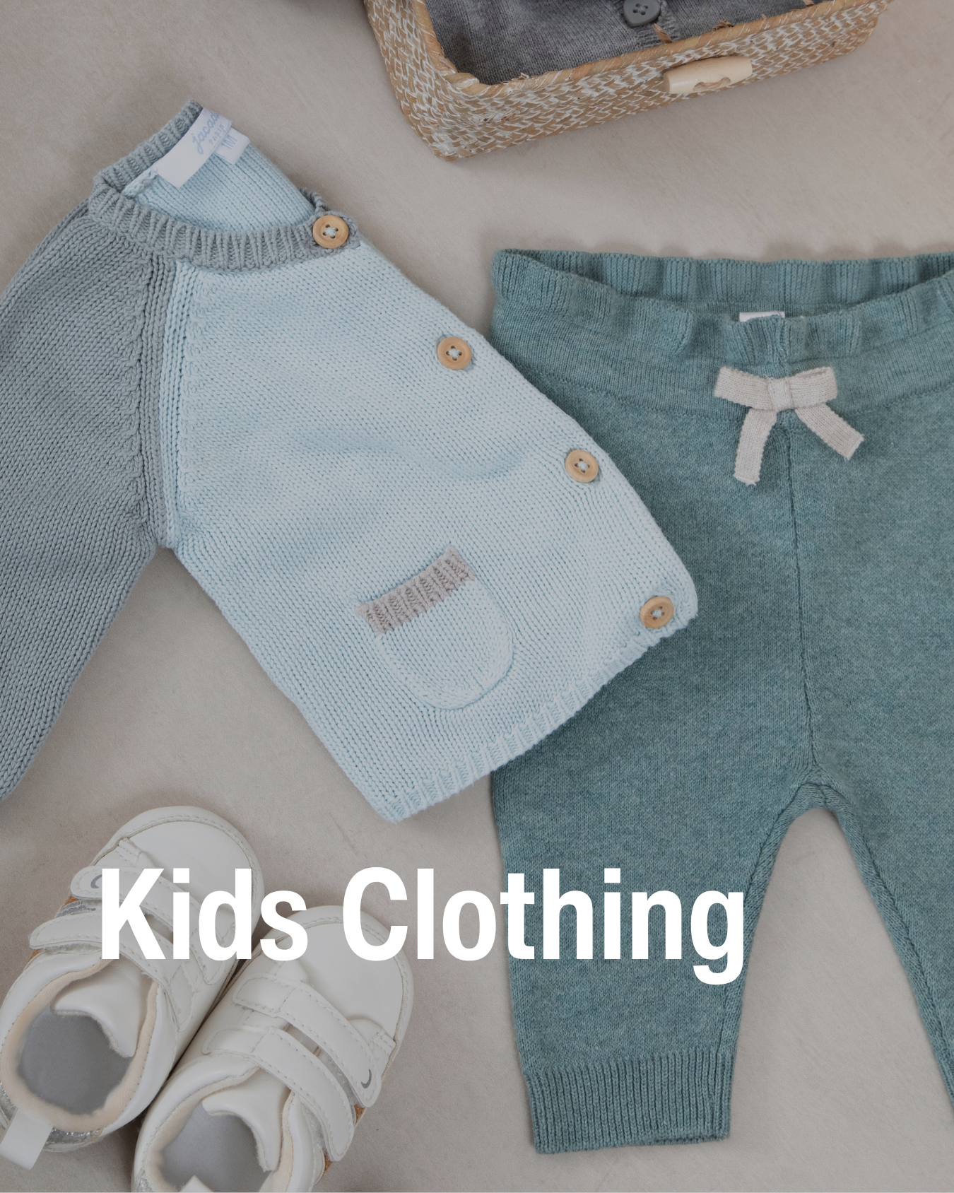 Flat lay of kids’ knit sweater, pants, and white shoes showing the kids clothing resale sold at Chic Kids.
