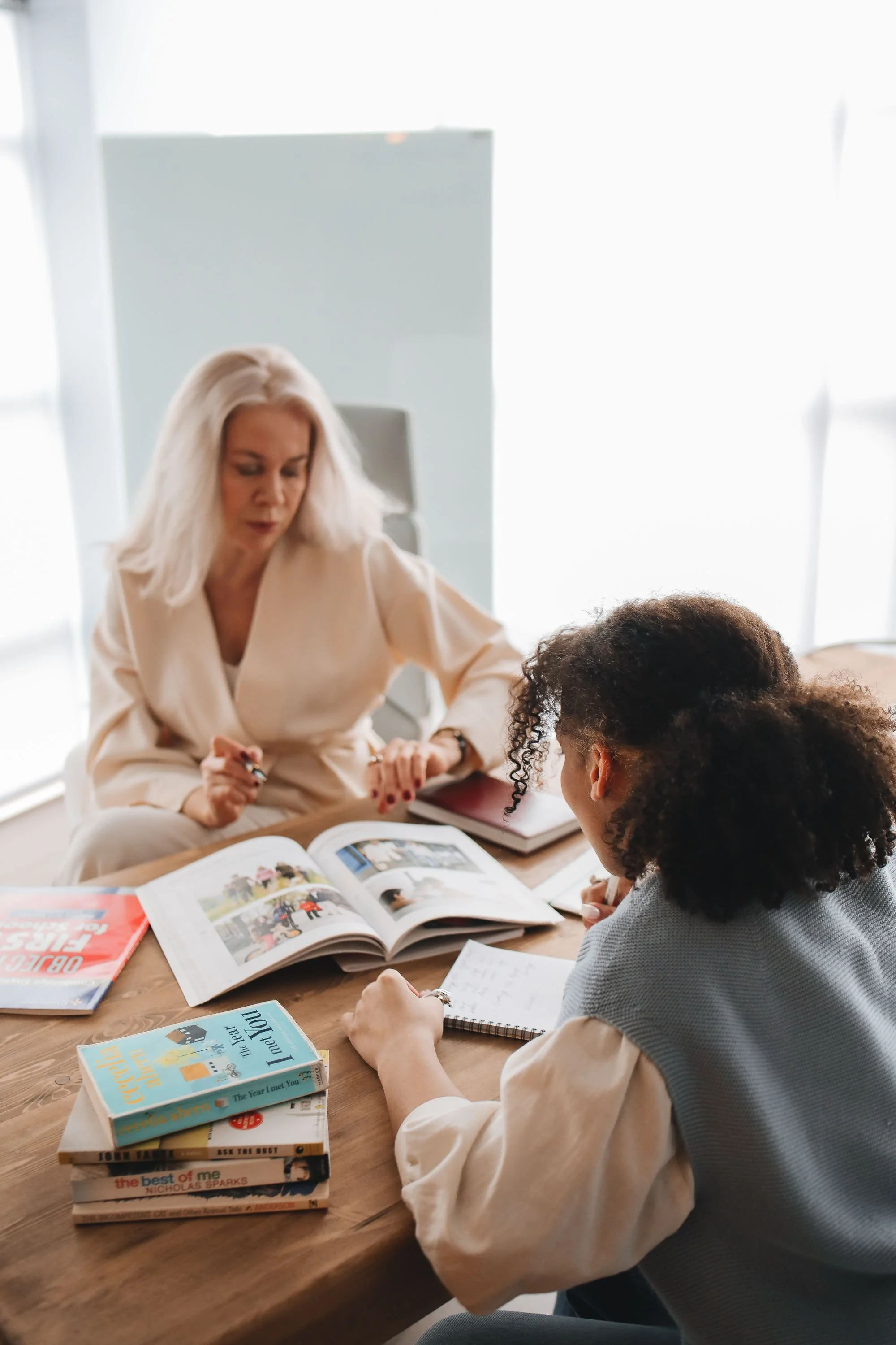 A young teenager studying with a tutor