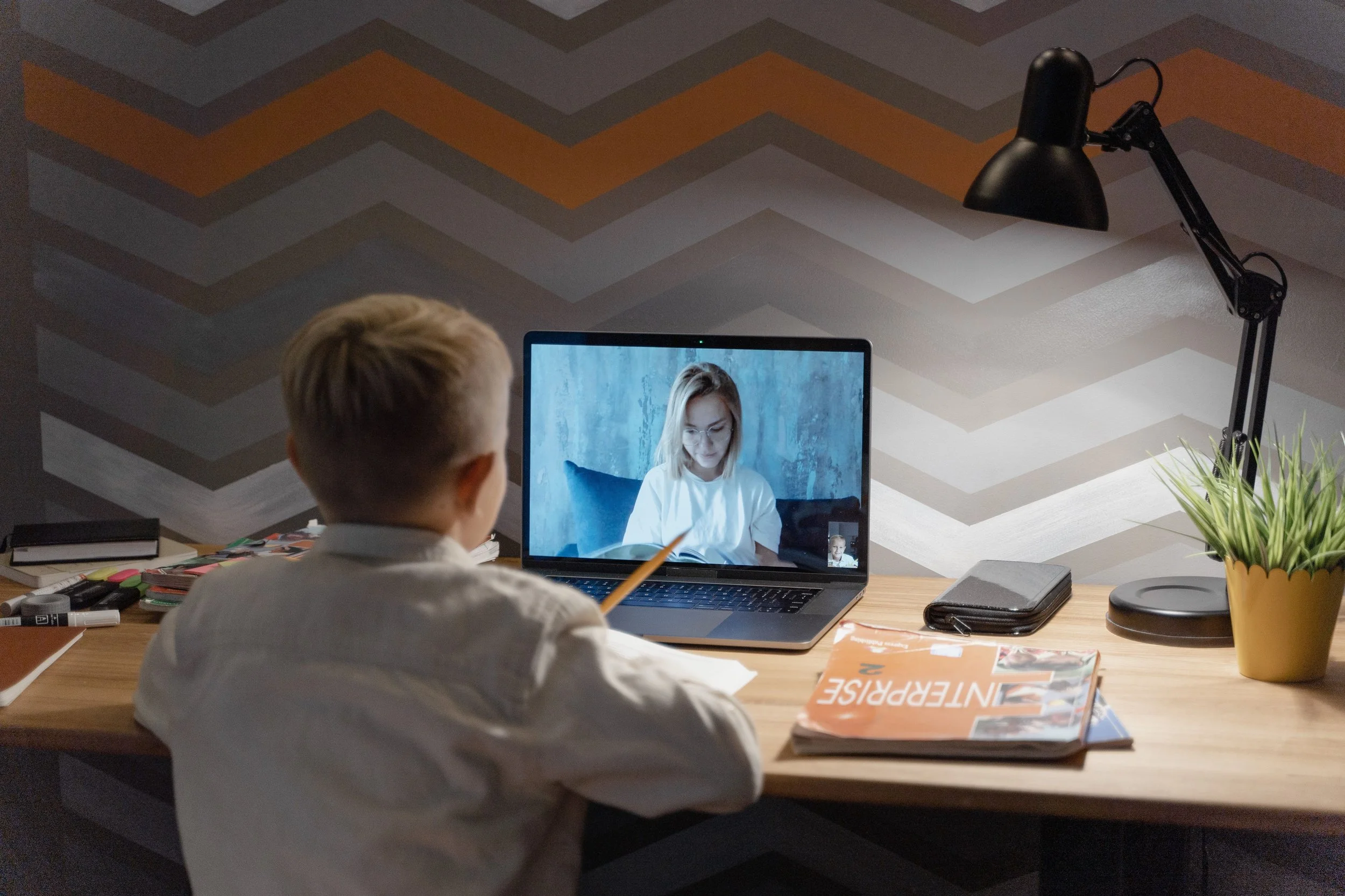 A little boy doing online tutoring