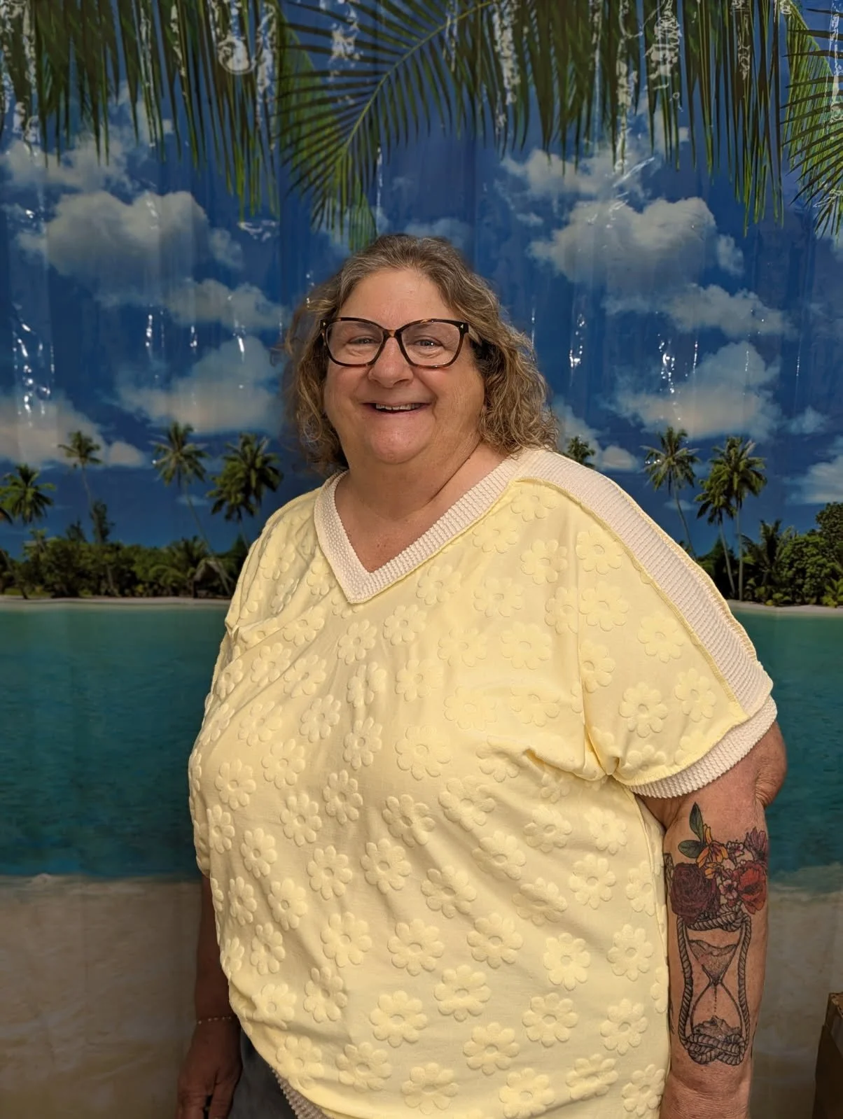 Wynne poses in front of a backdrop of a beach scene as she prepares to travel around Europe and Asia.
