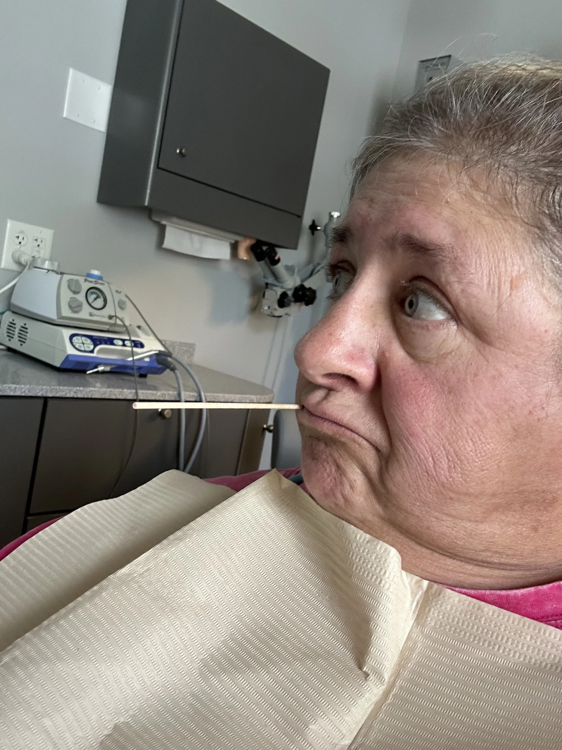 Wynne Penn sits in the dentist chair waiting to get her tooth fixed.