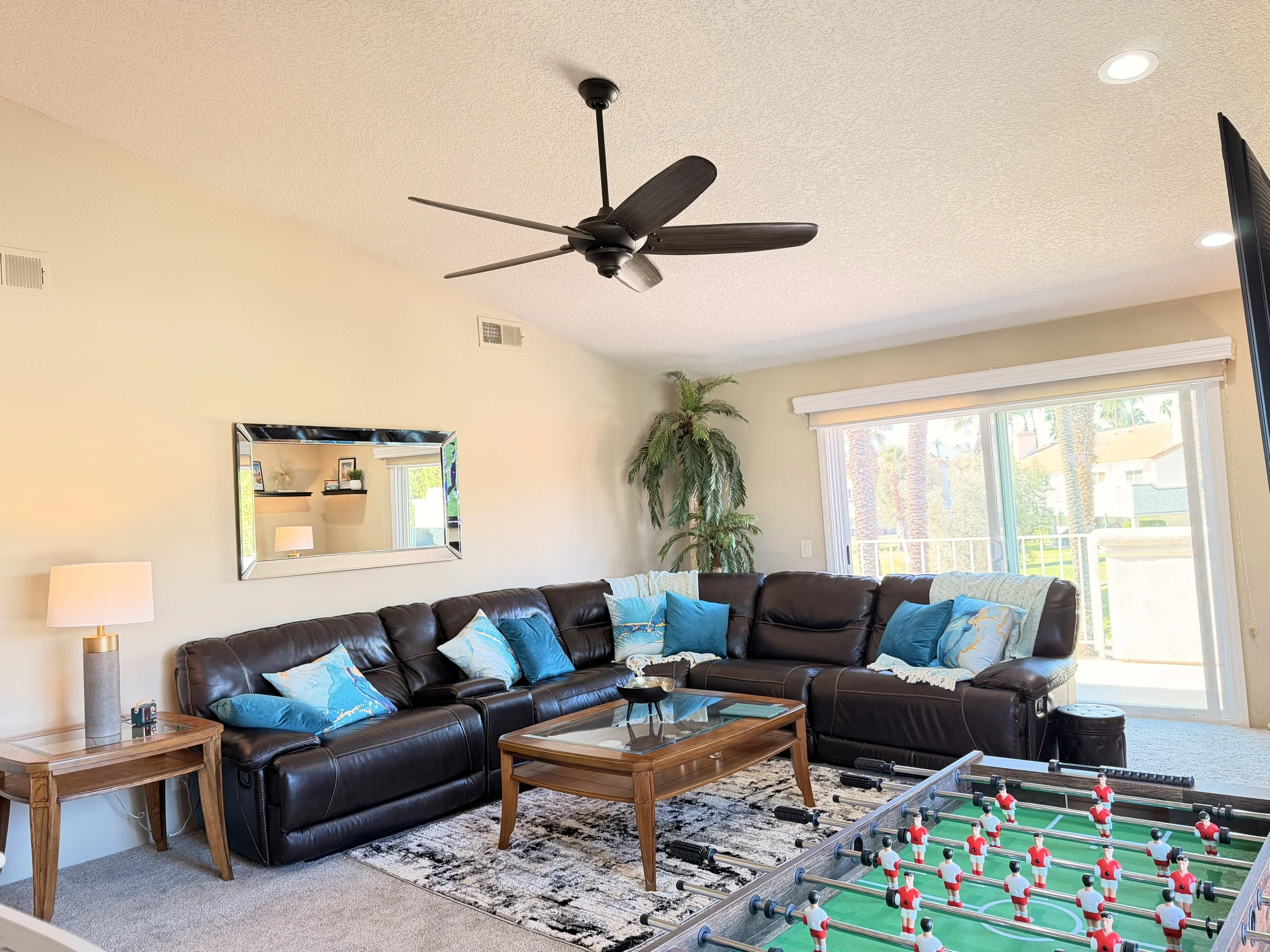 Living room with foosball table, 85" TV, games